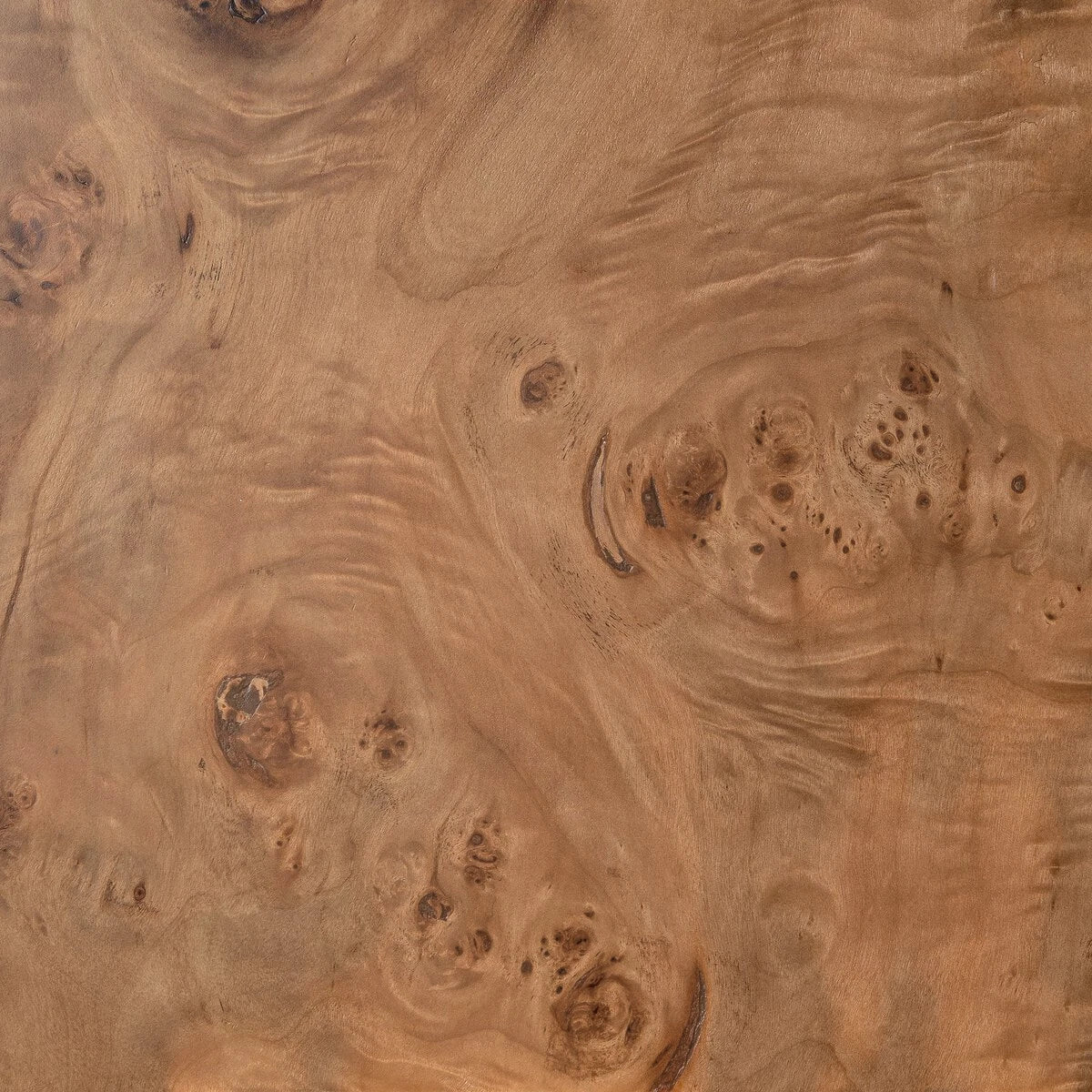 Detail view of the Eclipse Desk burl wood finish, highlighting the natural knots, swirling grain and tonal variation of the veneer.
