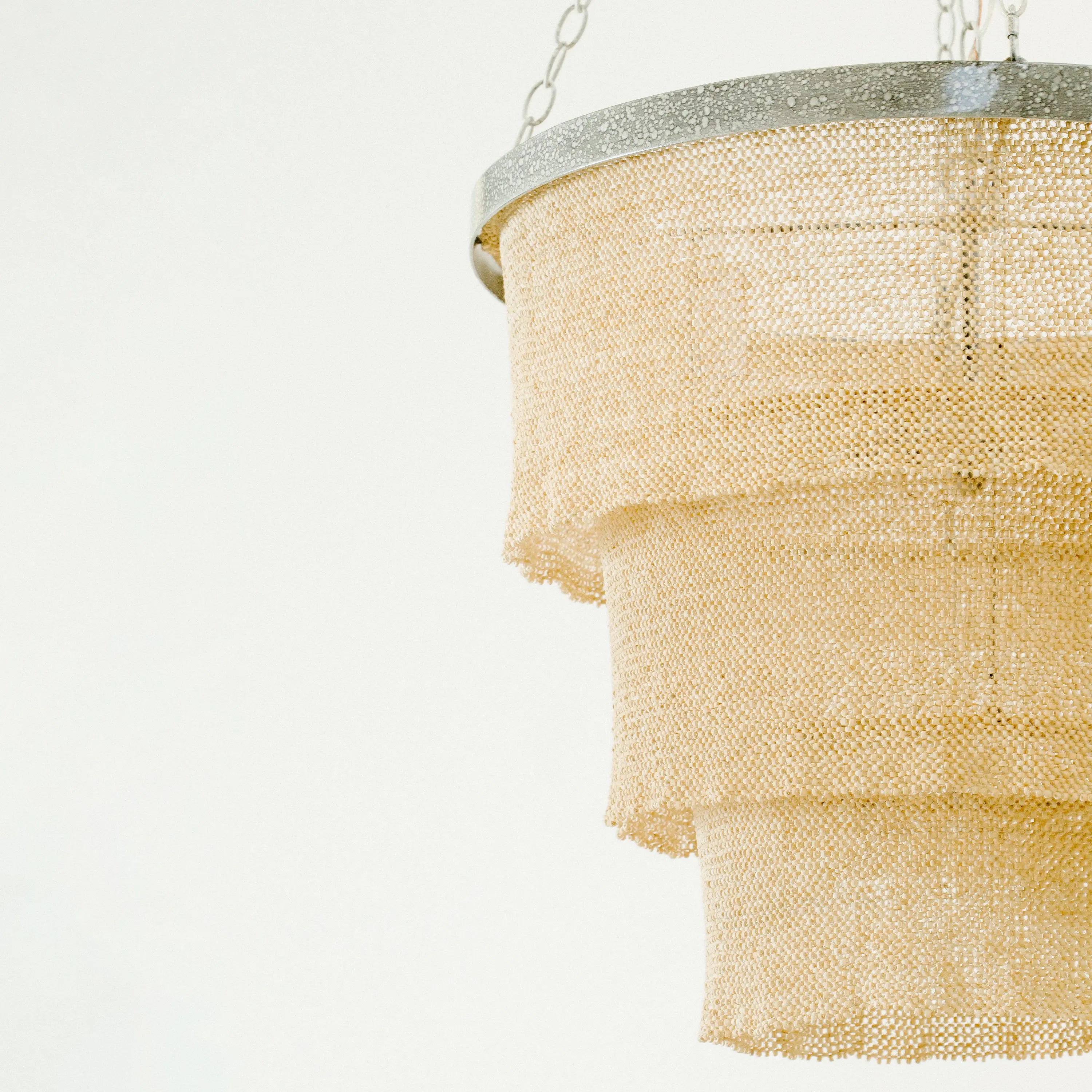 The Tiered Coco Bead Chandelier features clingy panels.