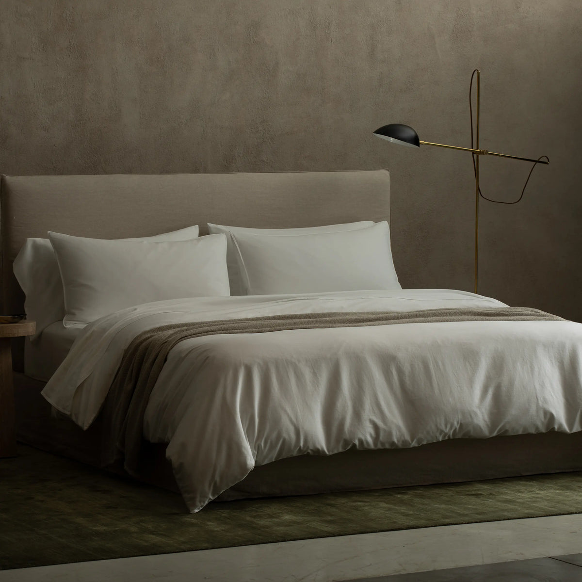 A minimalist floor lamp with an adjustable arm and exposed wire for a contemporary feel.