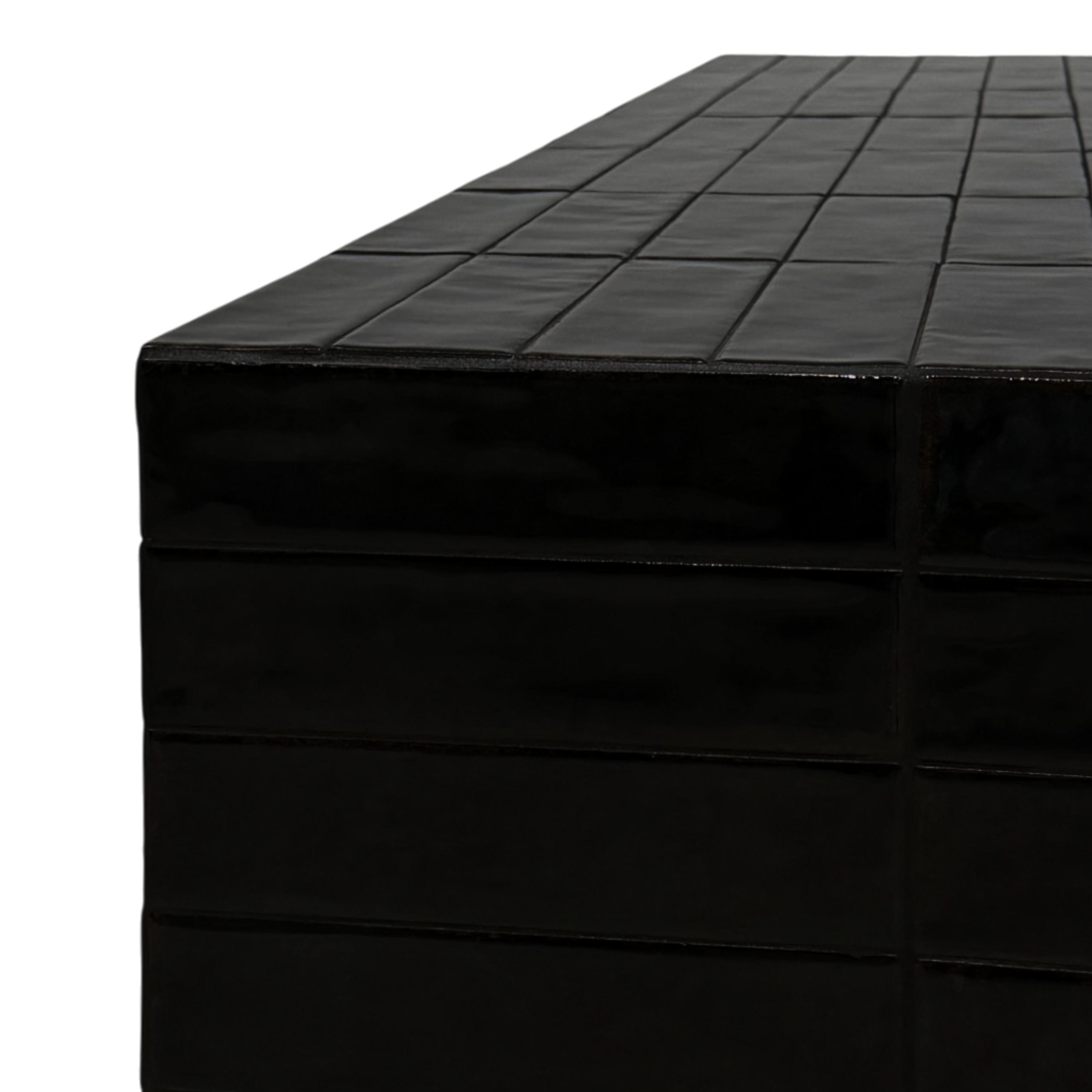 Close-up of a glossy black tiled rectangular surface, showing the top and side panels with a reflective finish against a white background.