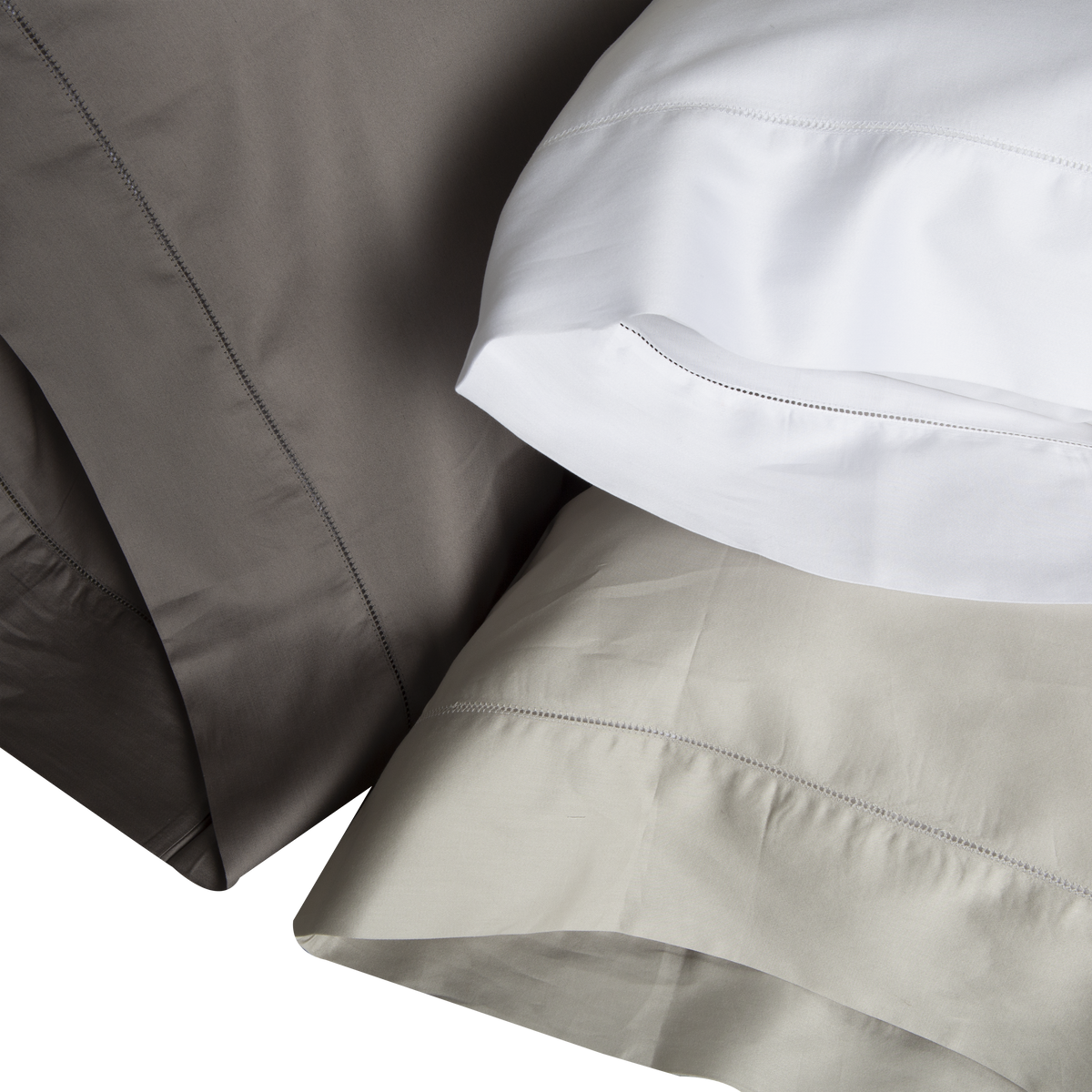 An elegant row of open hemstitching frames this silky, soft sateen collection.