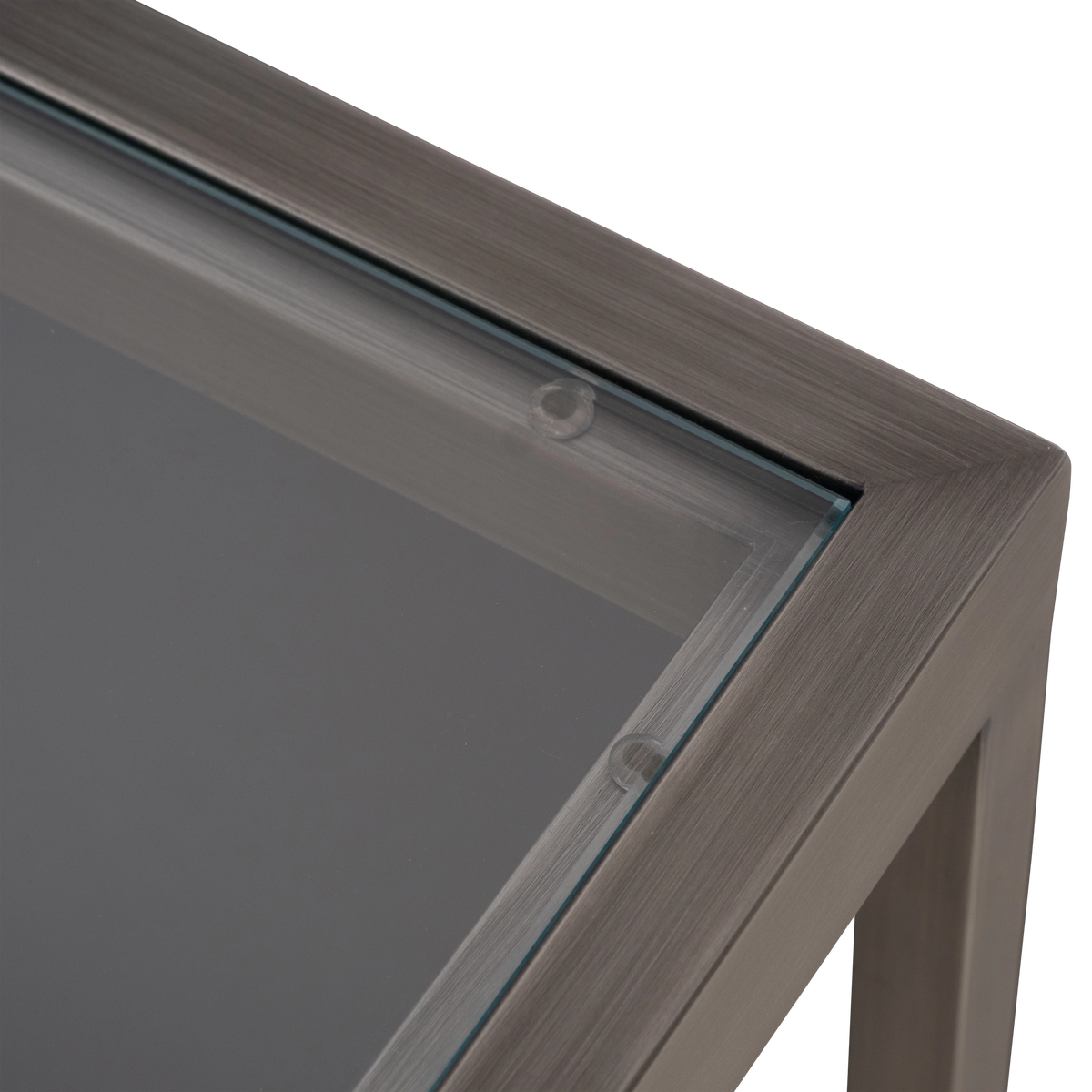 Tenor Console Table in Aged Pewter, angled view highlighting the long glass top, the square-tube legs, and the X-shaped base.