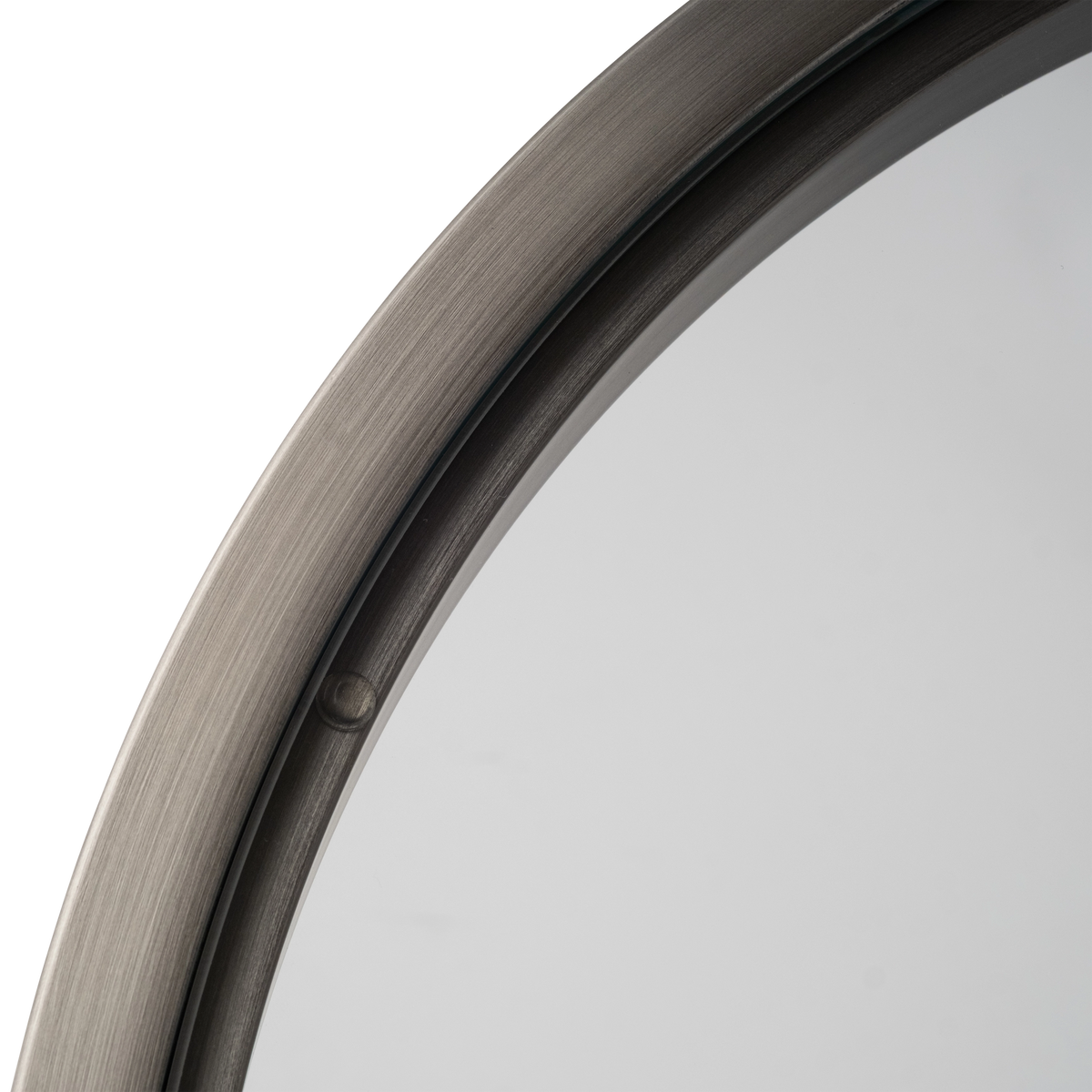 Close-up of the top edge of the Tenor Side Table in Aged Pewter, showing the curved brushed metal ring, the clear glass set inside it, and a small round pad holding the glass in place.