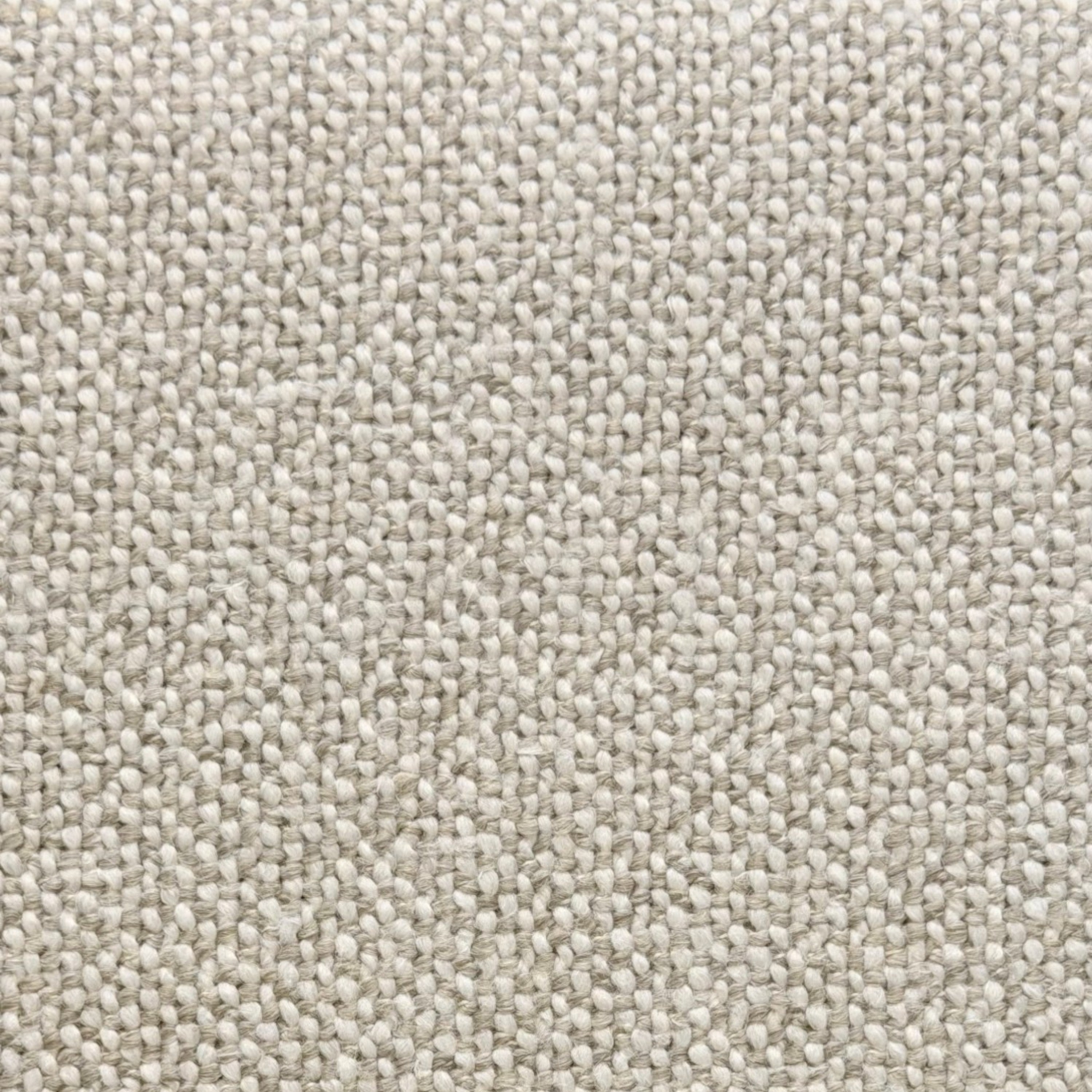 A close-up texture shot of a woven fabric in a warm off-white or cream color, showing the detailed knit pattern.