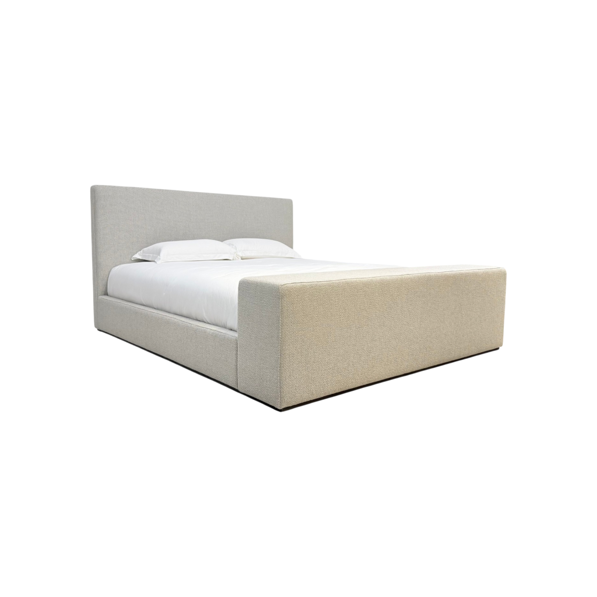 Vital King Bench Footboard Bed in textured neutral fabric, angled view highlighting the architectural headboard and wide upholstered footboard.