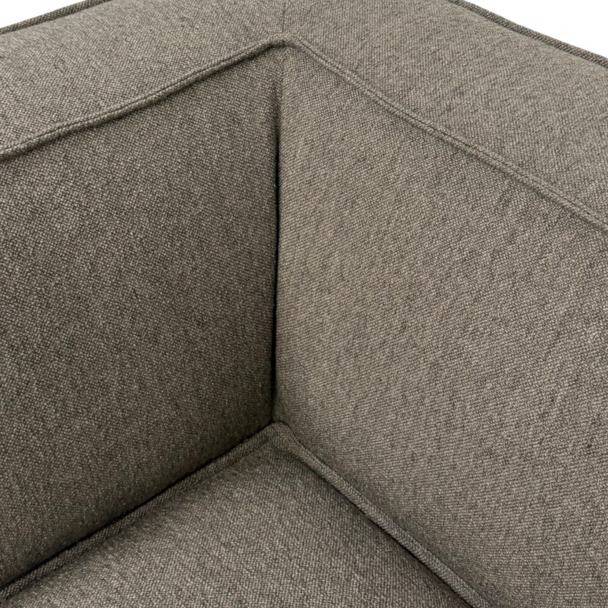 Close-up of the Vetro Modular Corner Chair showing the heathered brown woven upholstery, piped seams and cushioned corner construction.