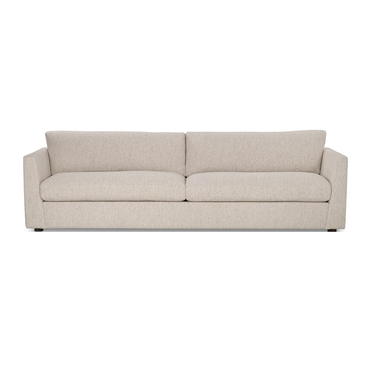 Kore Taper Arm Sofa shown from the front in Oatmeal textured fabric, with slim tapered arms, two seat cushions, two loose back cushions, and short dark feet.