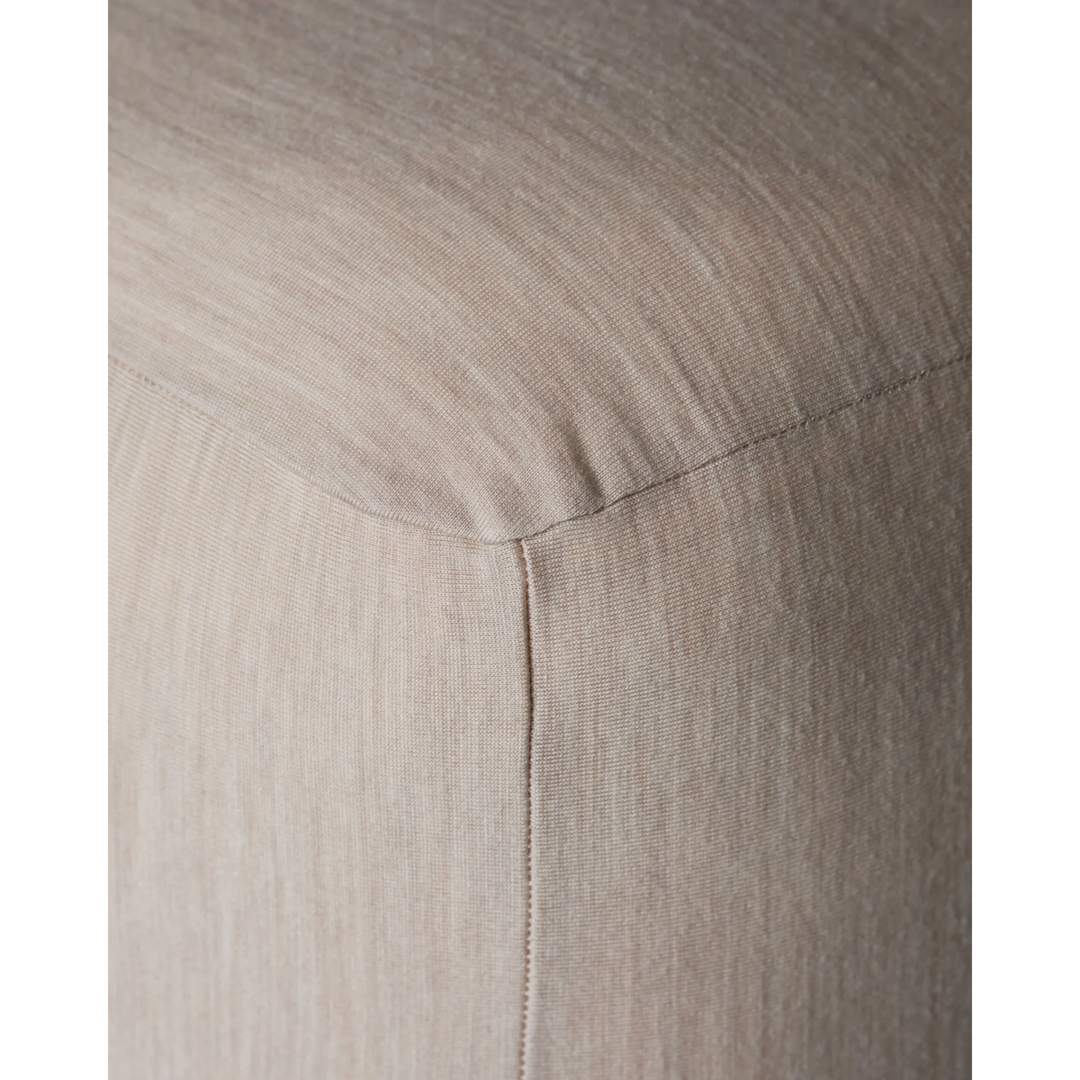 Close-up of Merino Fit Sheet King in Sand showing the smooth jersey texture, fitted corner and tailored seam detail.