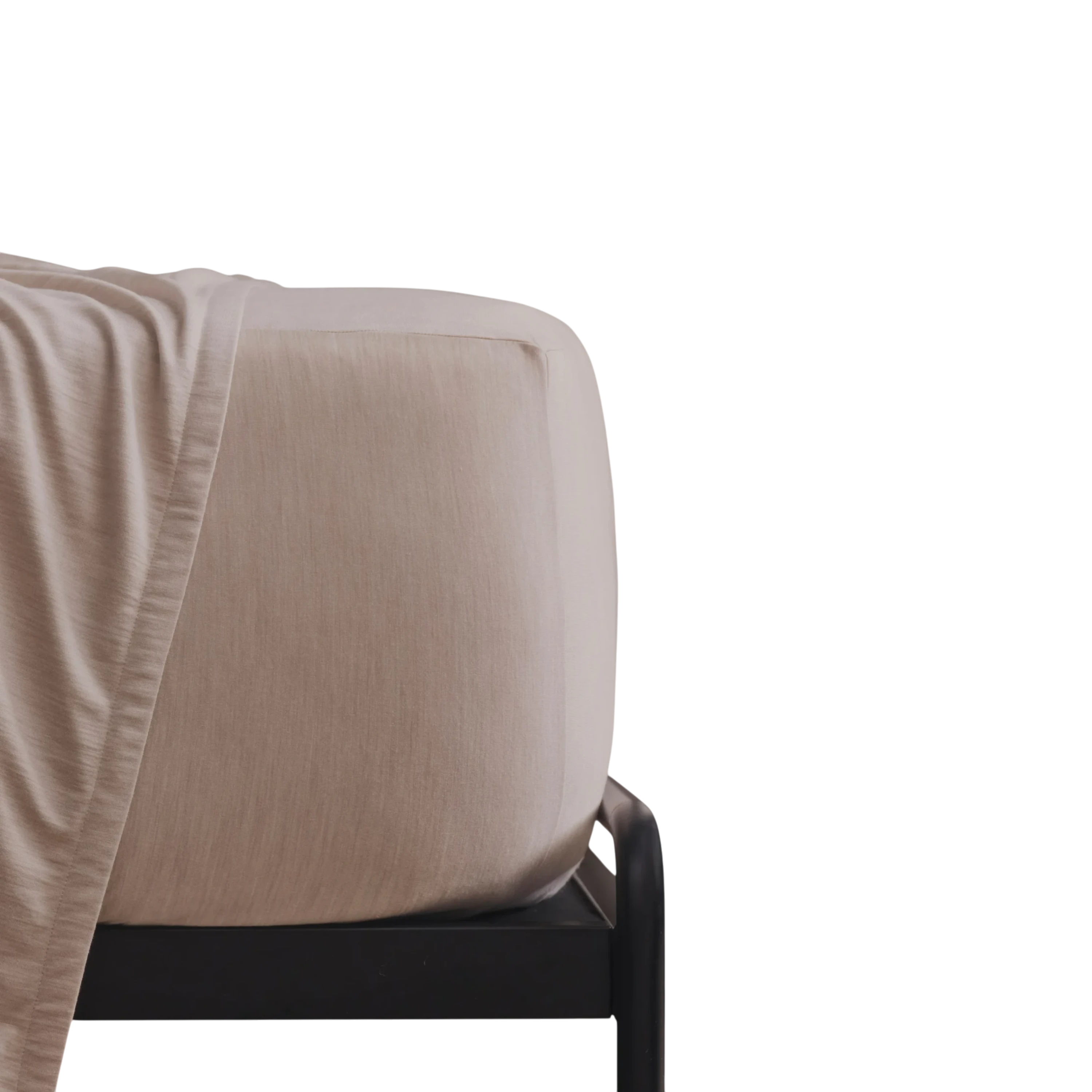 Merino Fit Sheet Queen in Sand Merino Jersey shown fitted over a mattress with coordinating bedding draped over the edge.