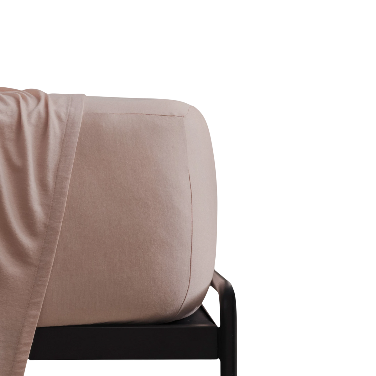 Merino Fit Sheet Queen in Rose Merino Jersey is shown fitted over a mattress with coordinating bedding draped over the edge.