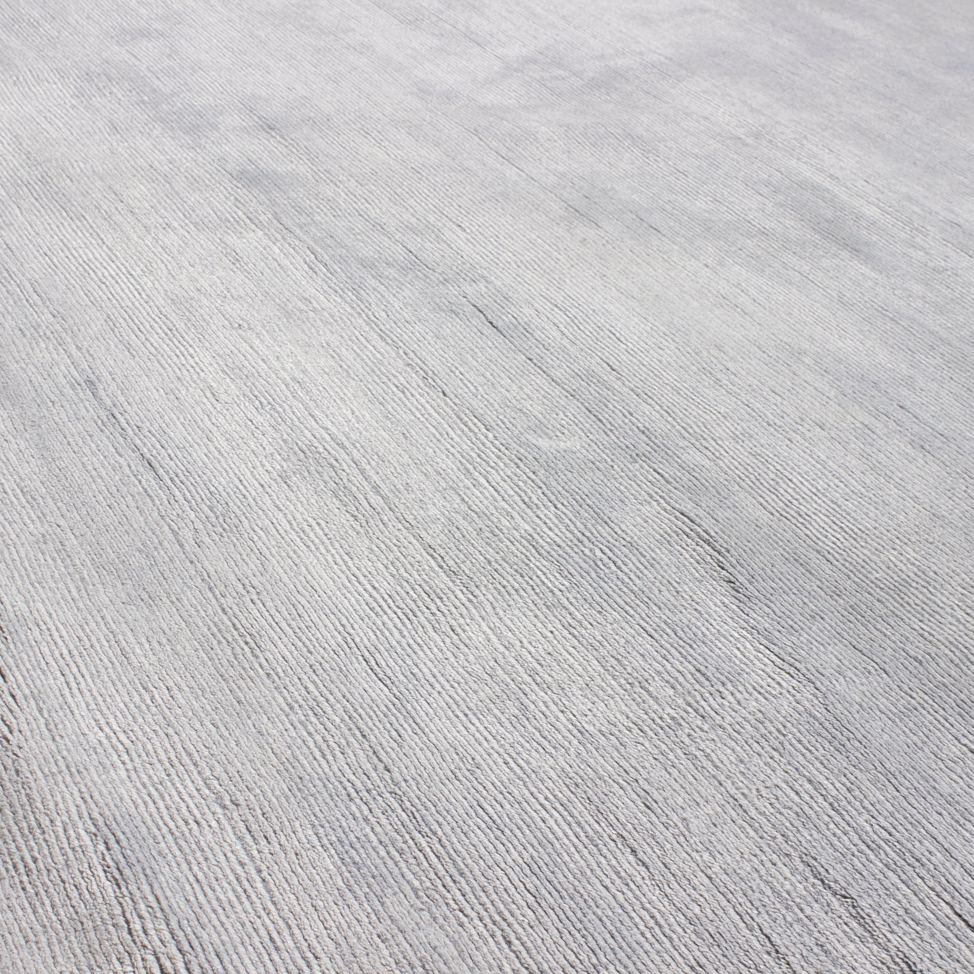 Through intricate weaves, knotting techniques and the use of colour, Elte's Solid and Textured rugs add warmth and depth to a space.