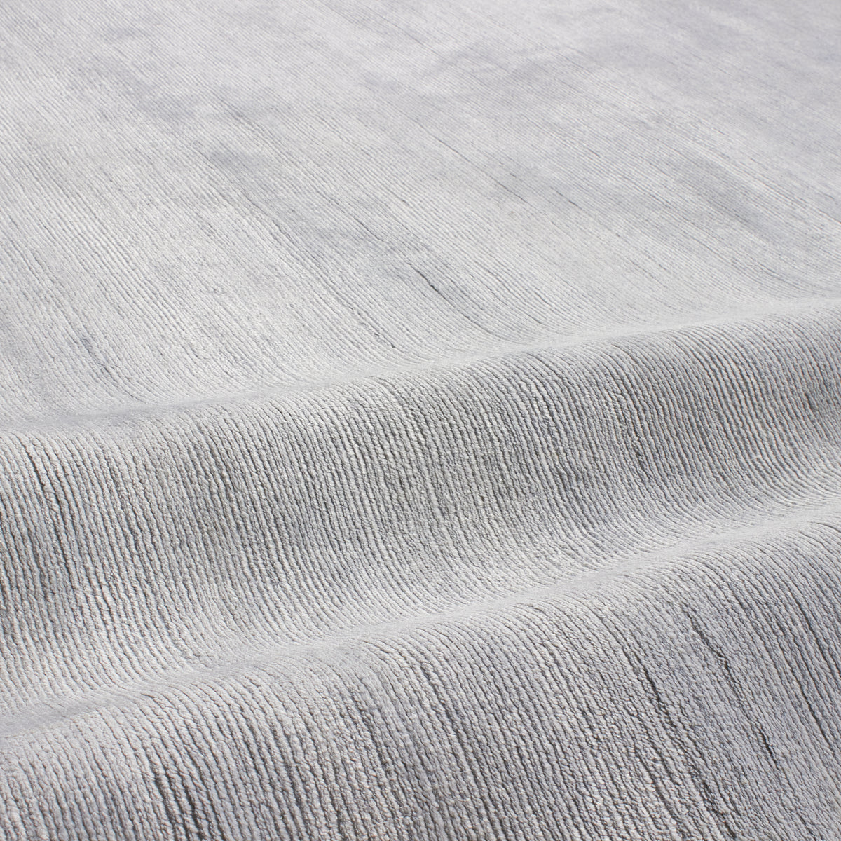 Through intricate weaves, knotting techniques and the use of colour, Elte's Solid and Textured rugs add warmth and depth to a space.
