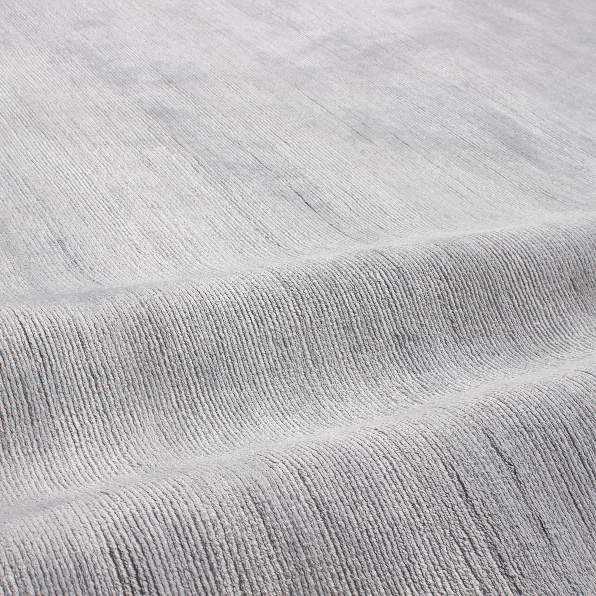 Through intricate weaves, knotting techniques and the use of colour, Elte's Solid and Textured rugs add warmth and depth to a space.
