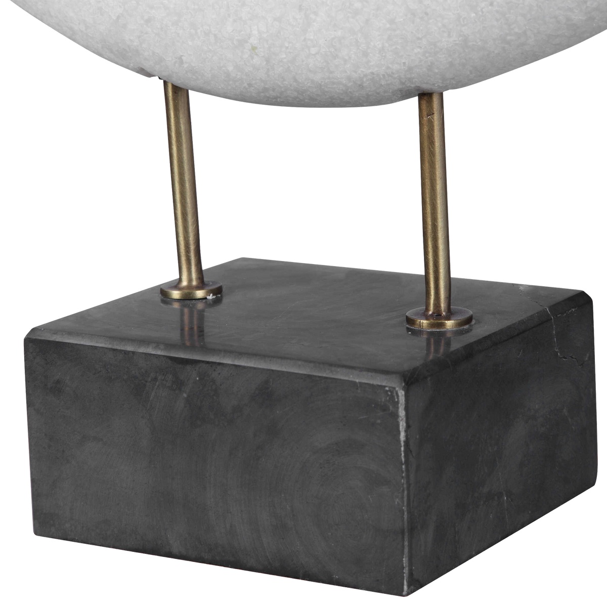 The monolithium shape executed in granulated marble that accurately replicates the look of Thassos marble with a honed black marble base and brass pegs is bound to become a highly