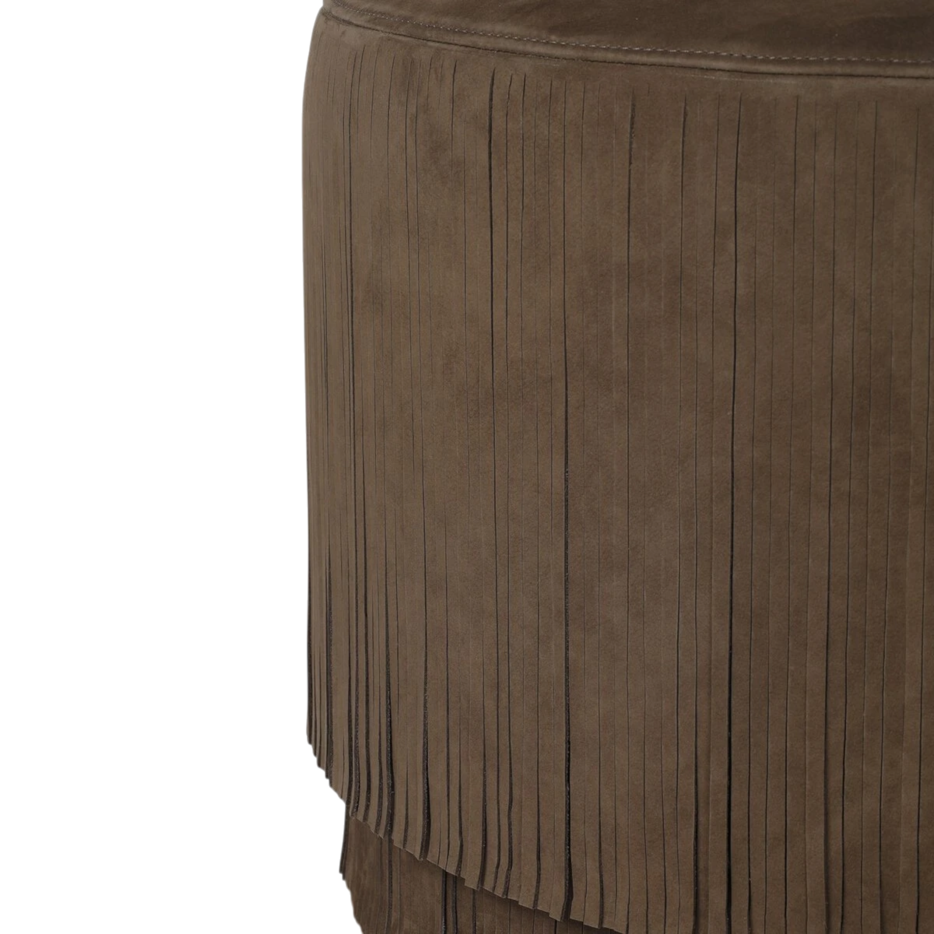 Close-up of a brown suede or faux-suede fringed Bauer Ottoman against a plain white background.