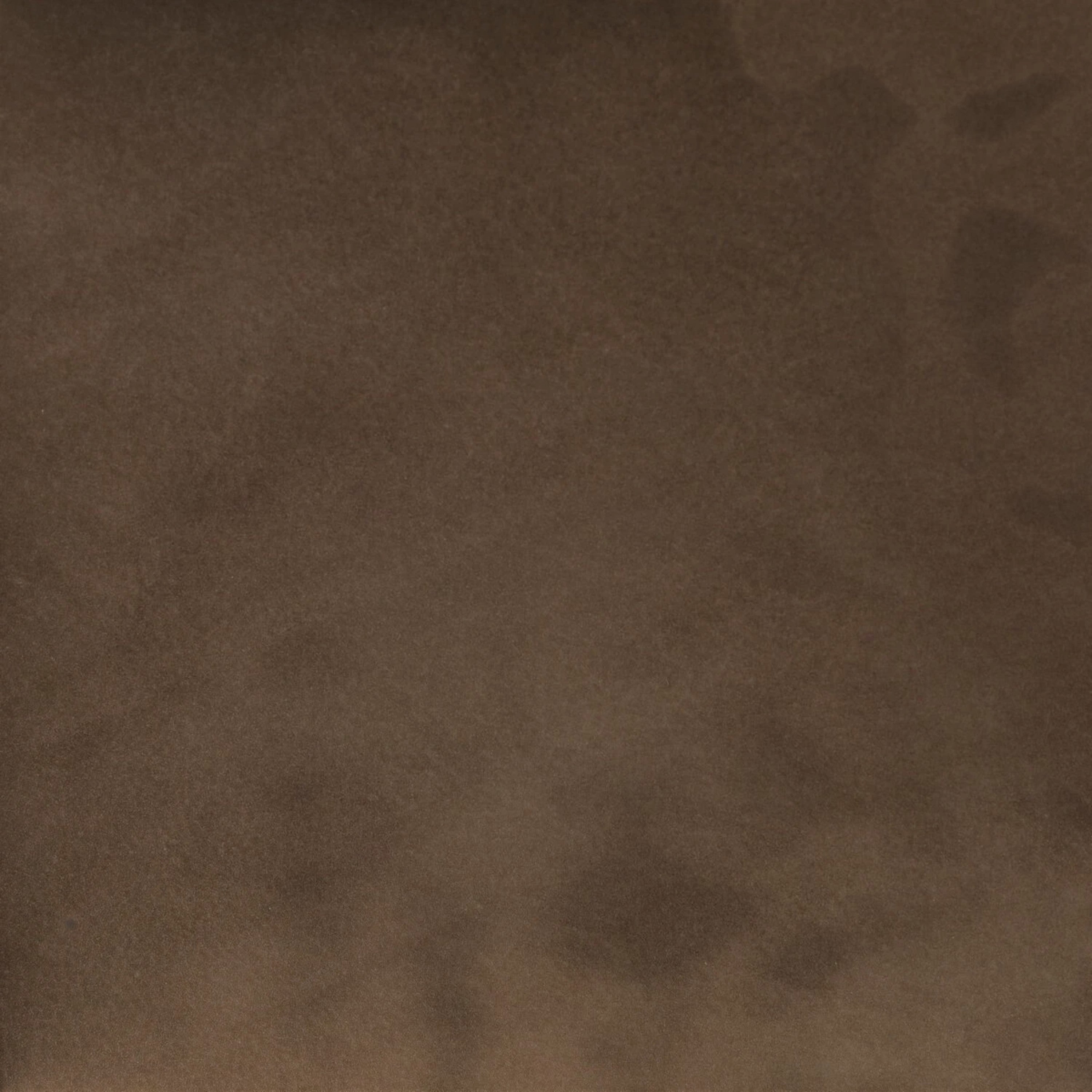 A close-up of a textured brown material, resembling suede for Bauer Ottoman.