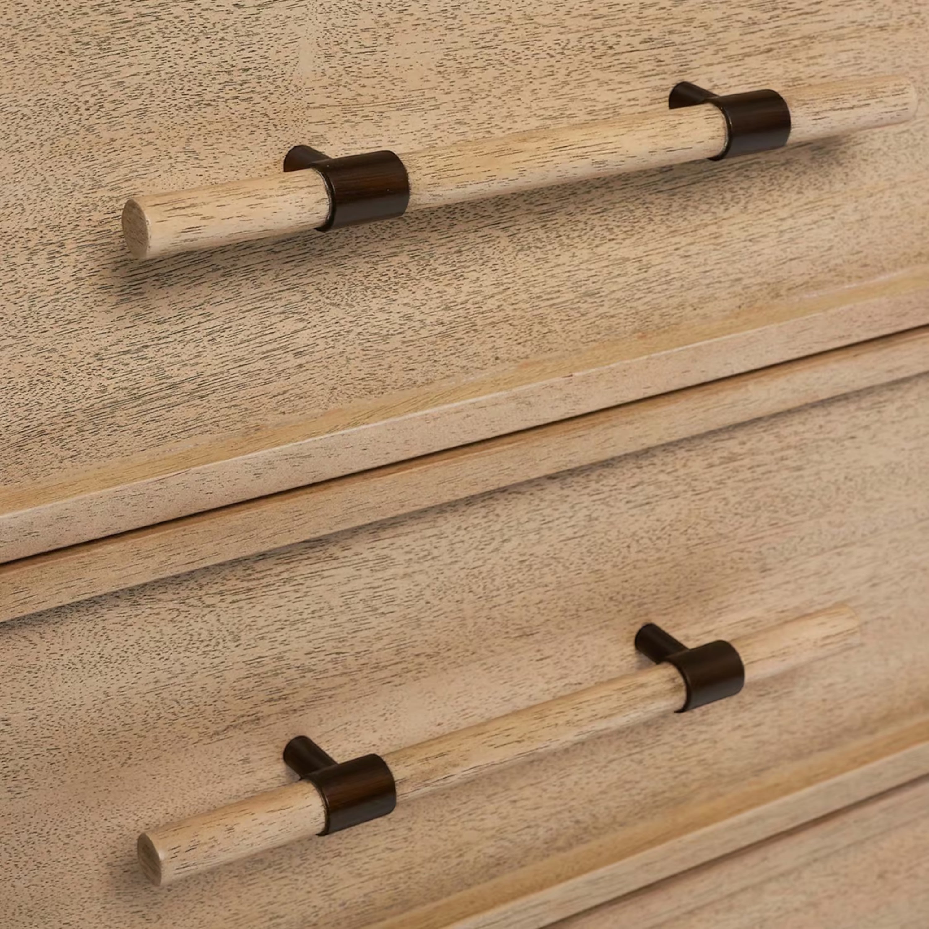 Close-up of the Sable Nightstand drawer fronts showing the textured wood grain and cylindrical wood pulls with dark metal brackets.