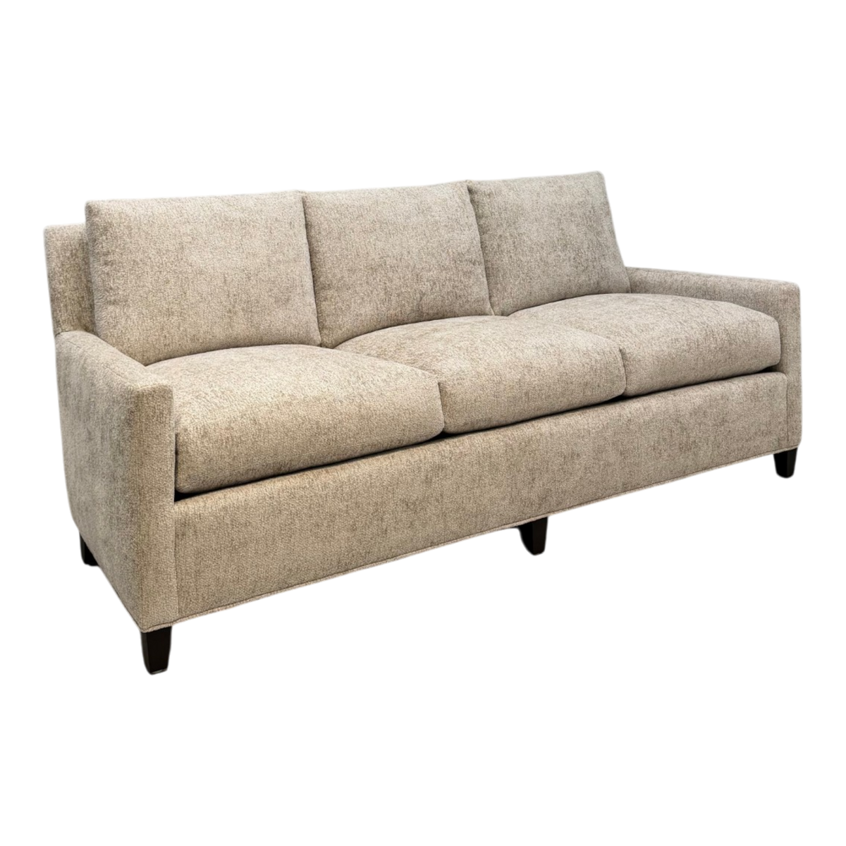 Angled front view of the Weston Sofa showing its three-seat configuration, relaxed cushions, tailored arms and textured sand-coloured chenille upholstery.