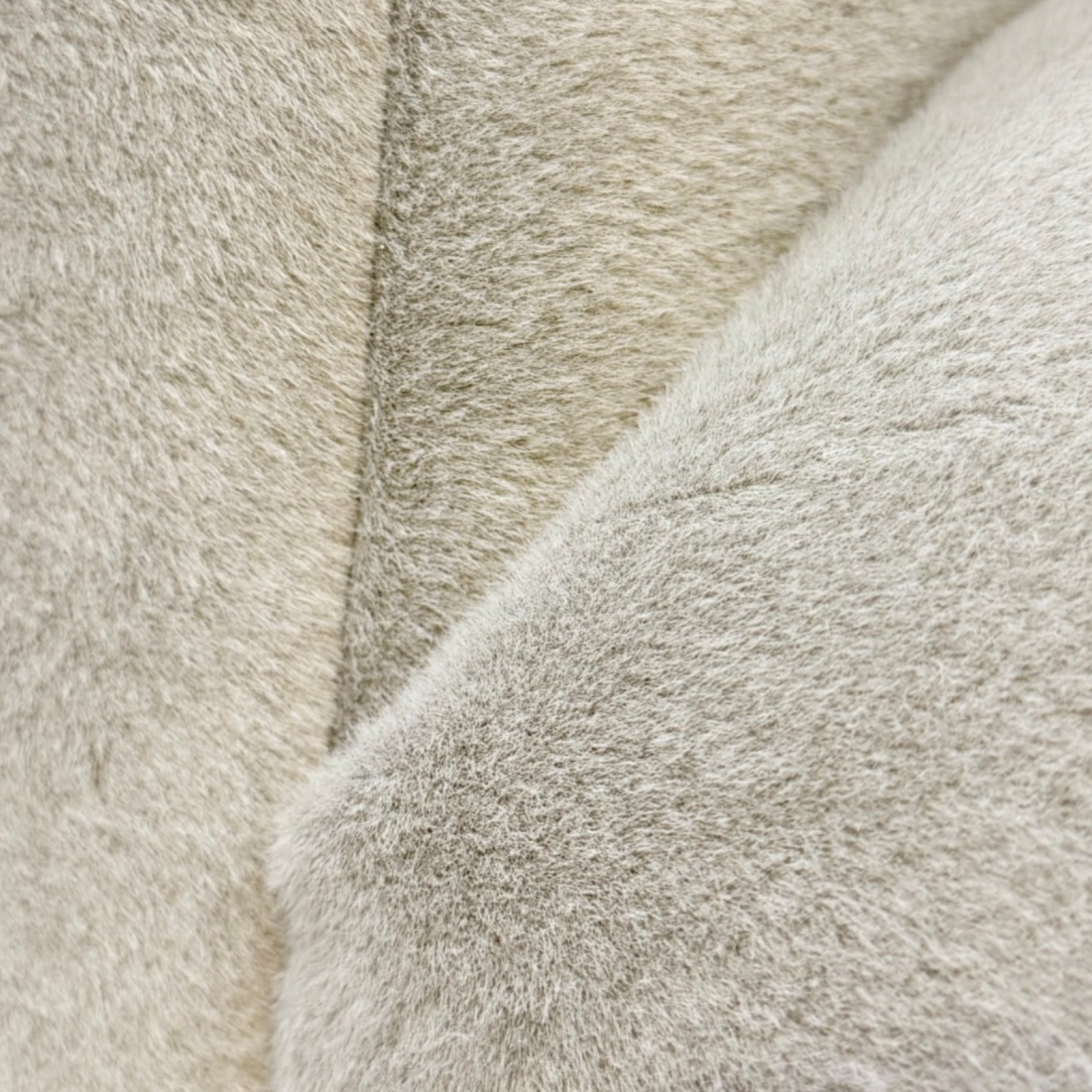 Bailey Swivel Chair upholstery detail showing the soft, textured ivory fabric across the curved back and seat.
