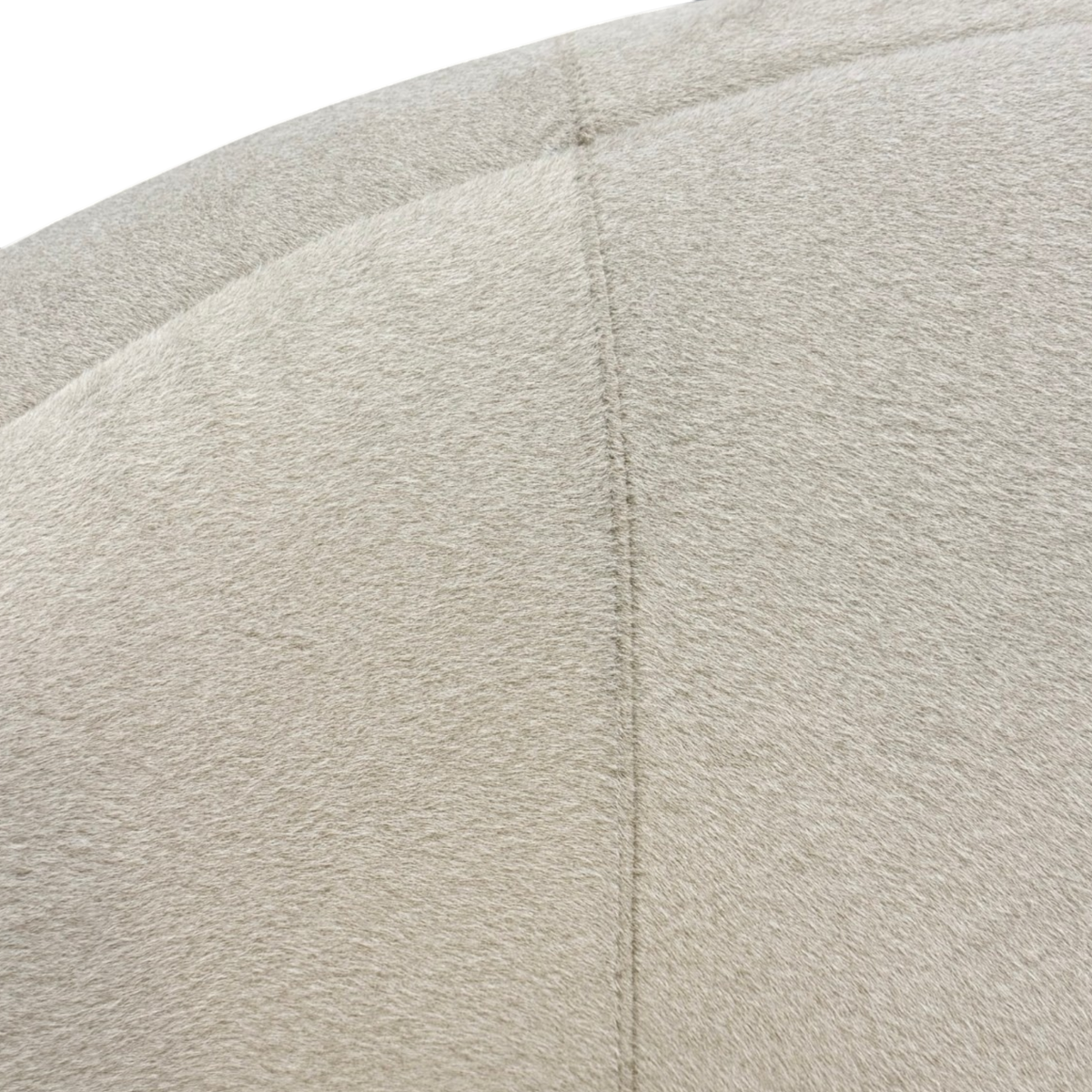 Bailey Swivel Chair close-up highlighting the fine ivory upholstery texture and tailored seam along the curved backrest.
