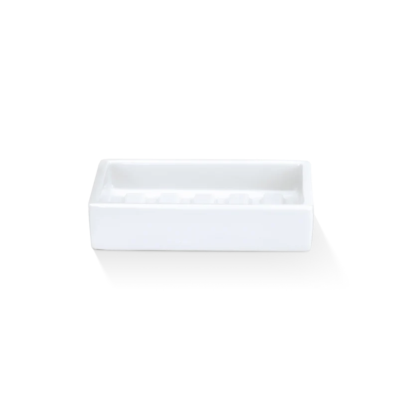 Porcelain Soap Dish shown from the front in white glossy porcelain, highlighting the ridged interior base, raised rim, and rectangular silhouette.