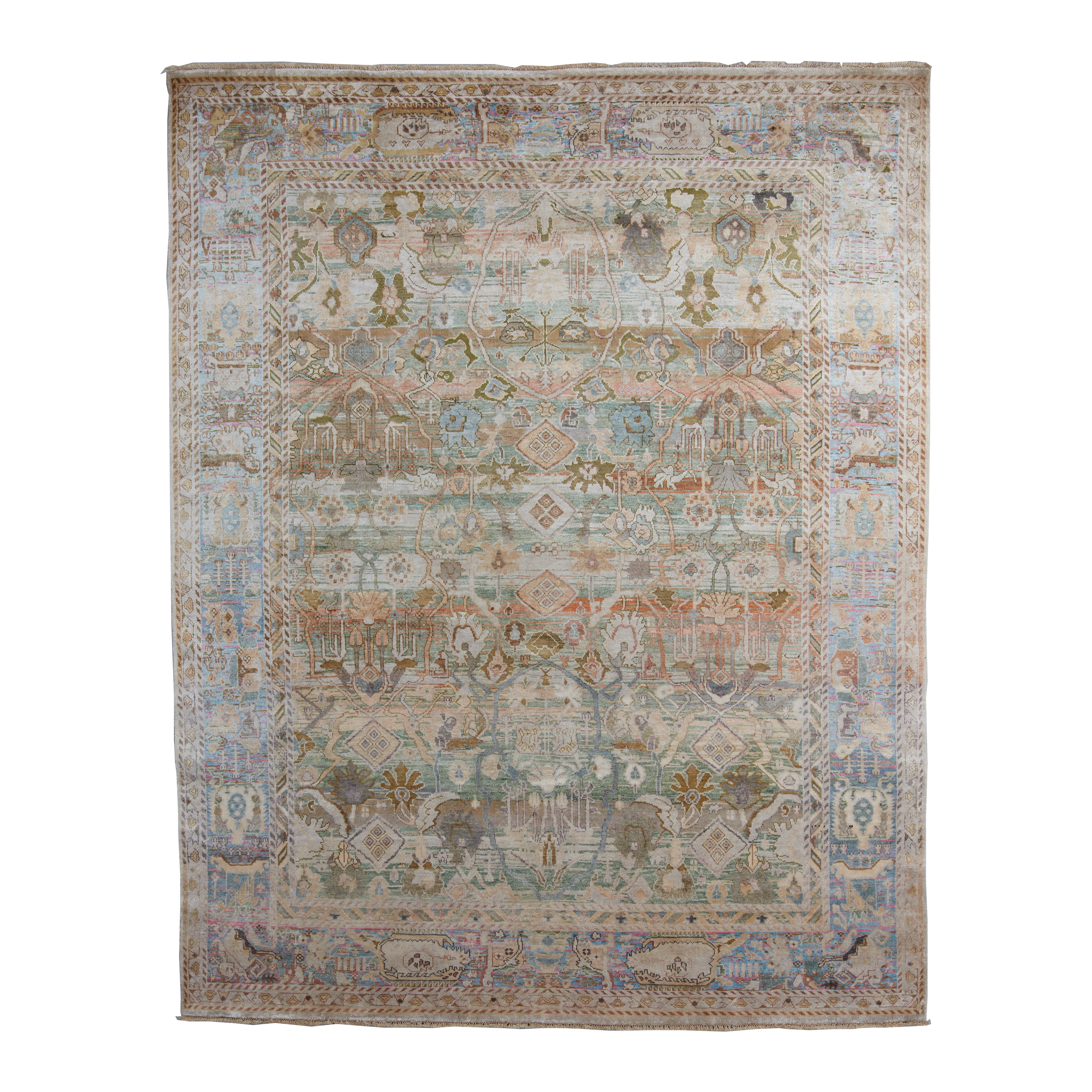 A rectangular vintage-style area rug with an intricate, distressed geometric and floral pattern in muted tones of beige, blue, green, and rust orange, shown flat against a white background.