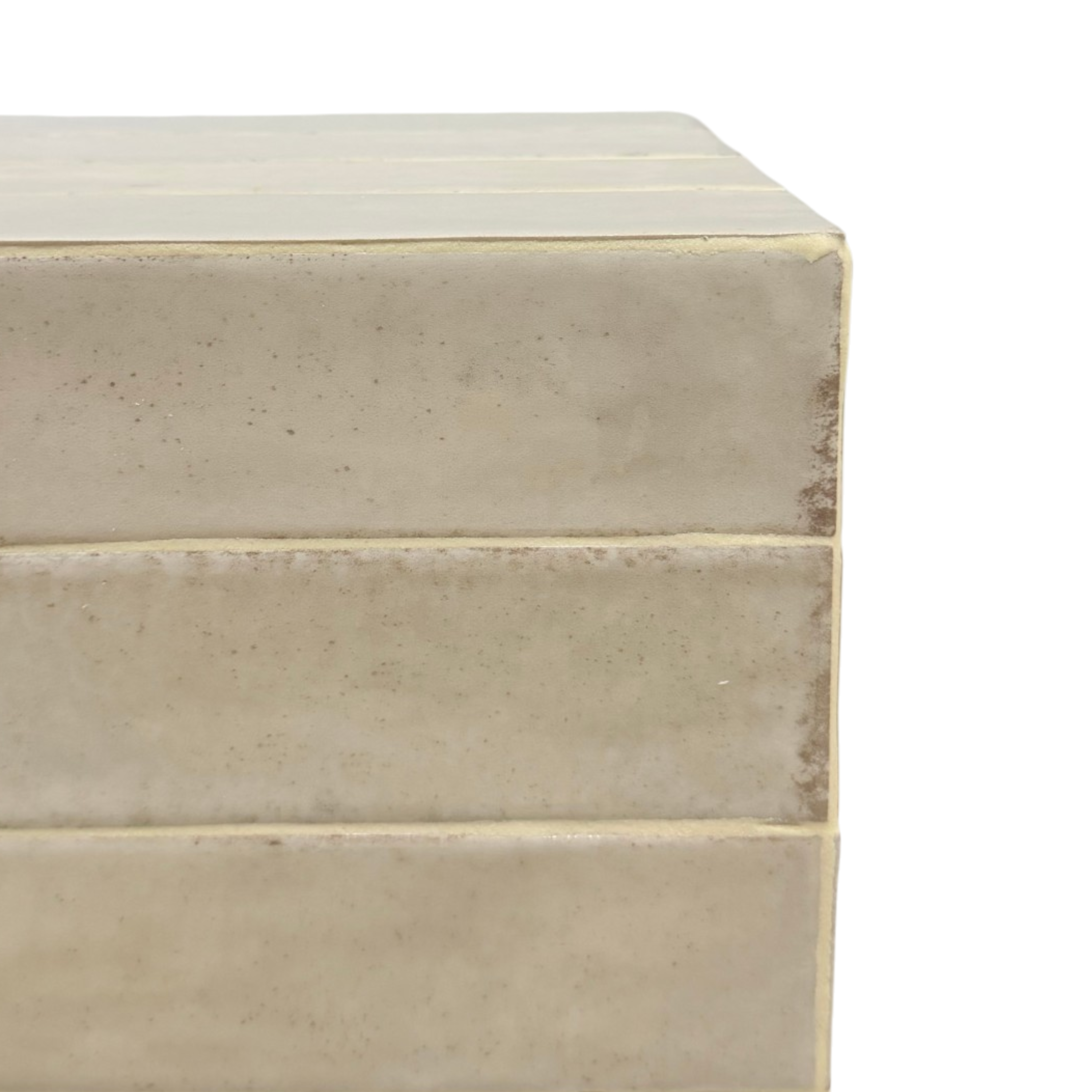 Close-up of the Bloor ivory side table, showing its subtly mottled surface, horizontal seams and softly irregular edges