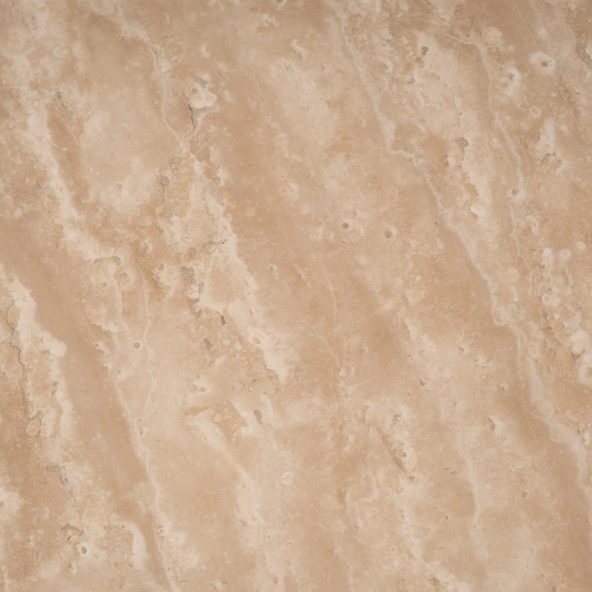 Aldo Coffee Table close-up showing warm beige Turkish travertine with flowing cream veining and natural pitting across a honed surface.