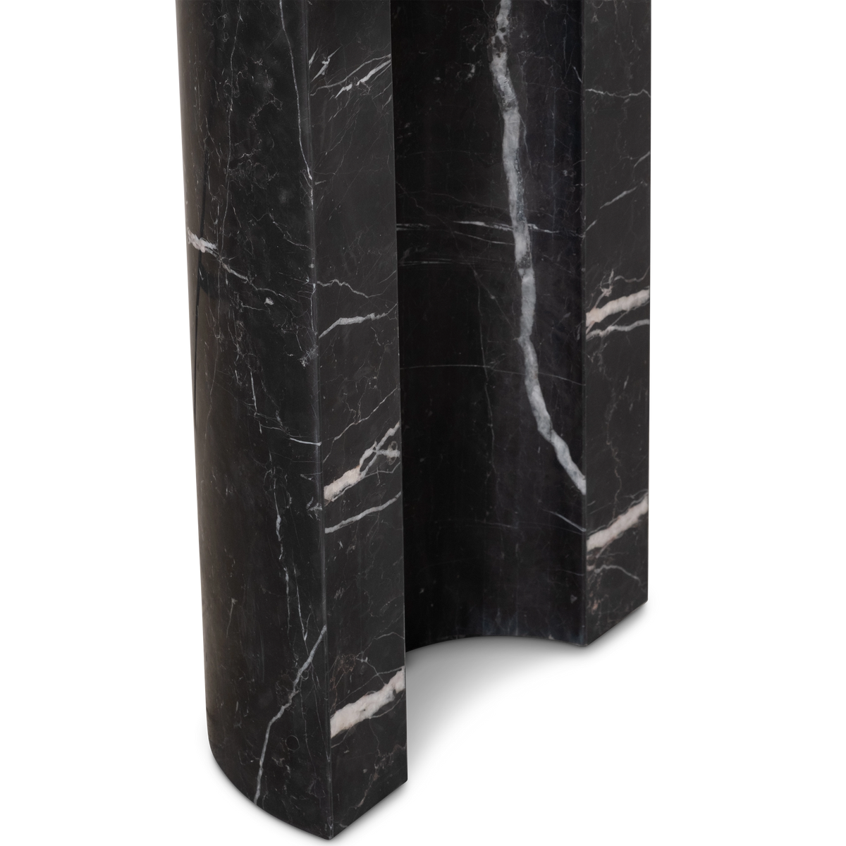 Shift Console Table close-up of a leg base in black Nero Marquina marble, showing the concave inner channel and white veins wrapping its edges.