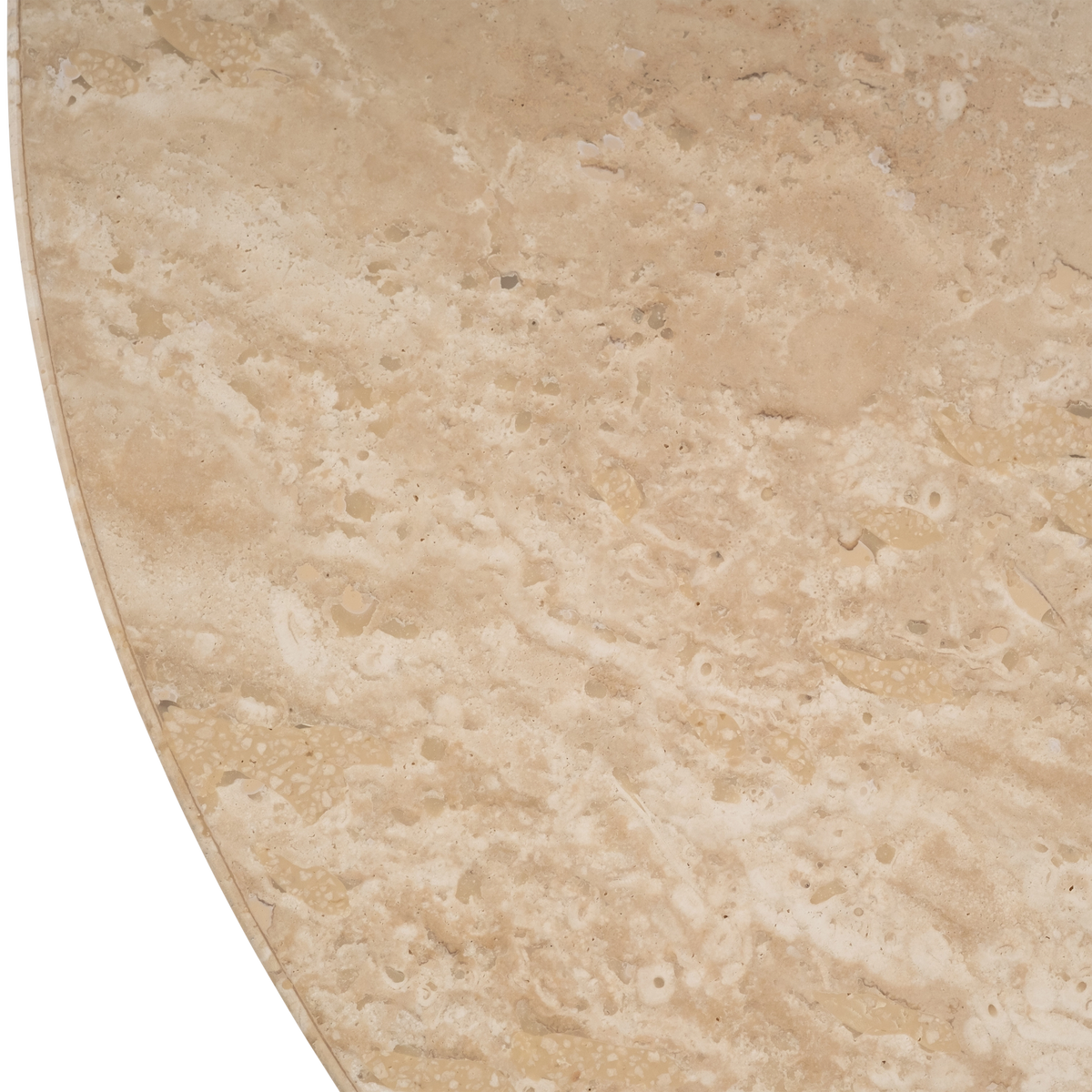 Close-up of the honed top of the Meta Round Side Table in Warm Beige travertine, with tan and cream mottling, small fossil-like voids, and a crisp rim along the curve.