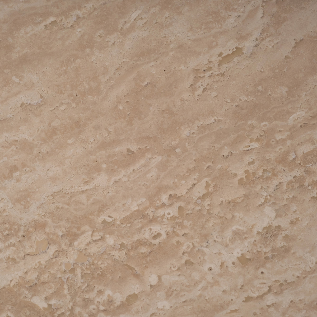 Balance Console Table detail view in warm beige Turkish travertine, highlighting the overhanging top and crisp edges where each stacked block shifts past the one below.
