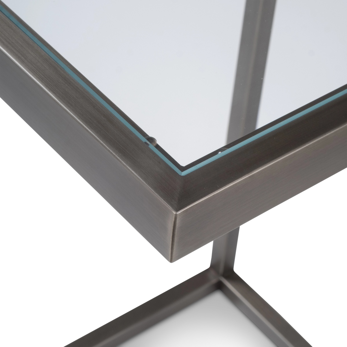 Tenor Pull Up Table in a three-quarter view in Aged Pewter brushed metal, showing the cantilevered glass top, single post and open base.