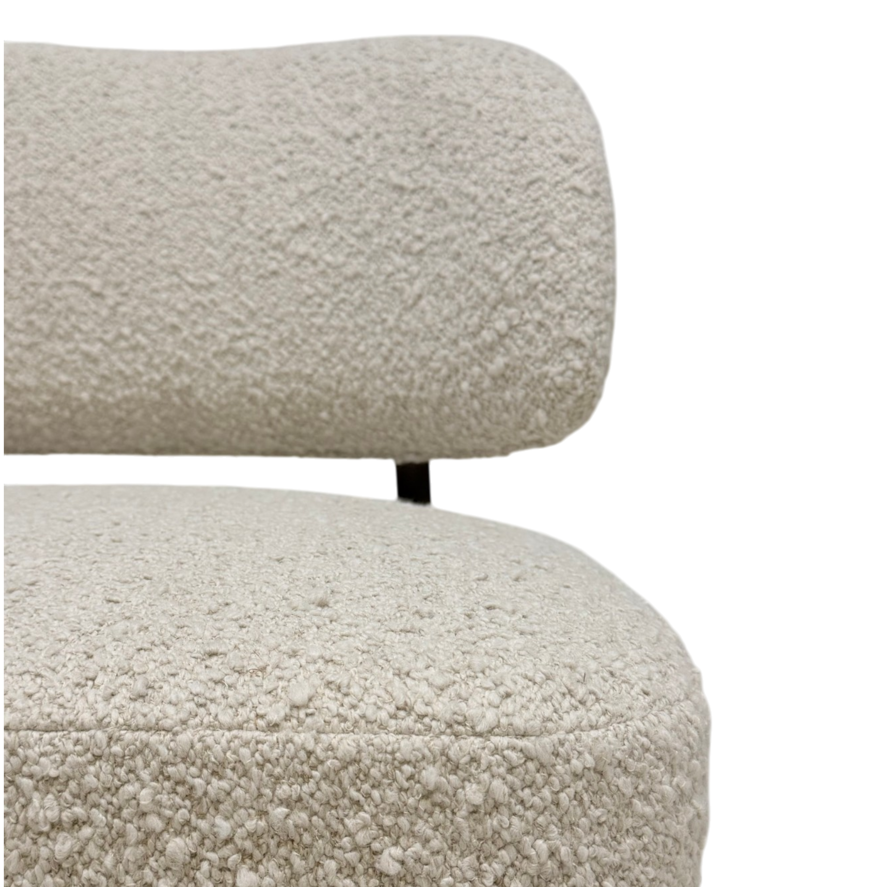 Close-up of a textured bouclé upholstered chair or sofa seat and back cushion in a warm off-white/cream color, with a small dark metal support visible between the cushion sections, on a plain white background.