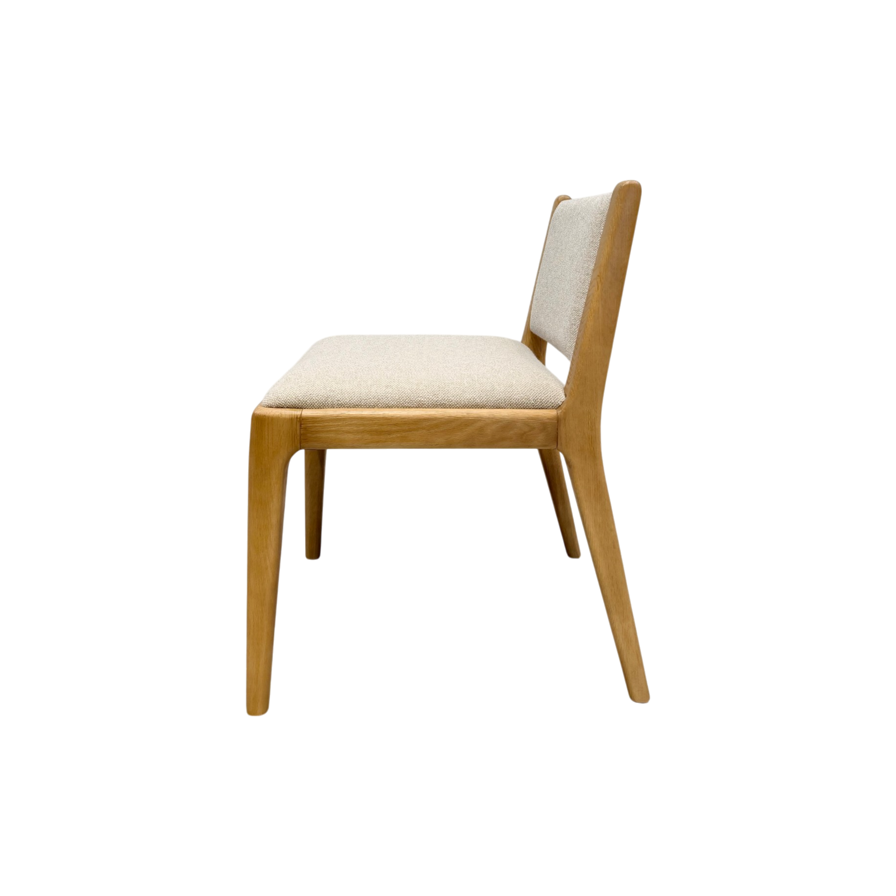 A modern wooden dining chair with a light beige upholstered seat and backrest, shown from a side profile view against a plain white background.