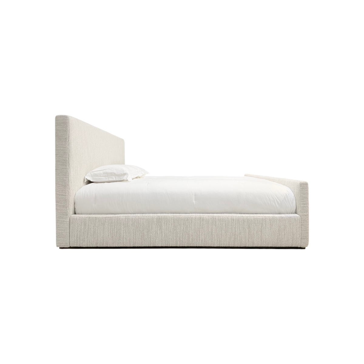 Vital Footboard King Bed side view highlighting the low upholstered frame, tall headboard, footboard and white bedding.