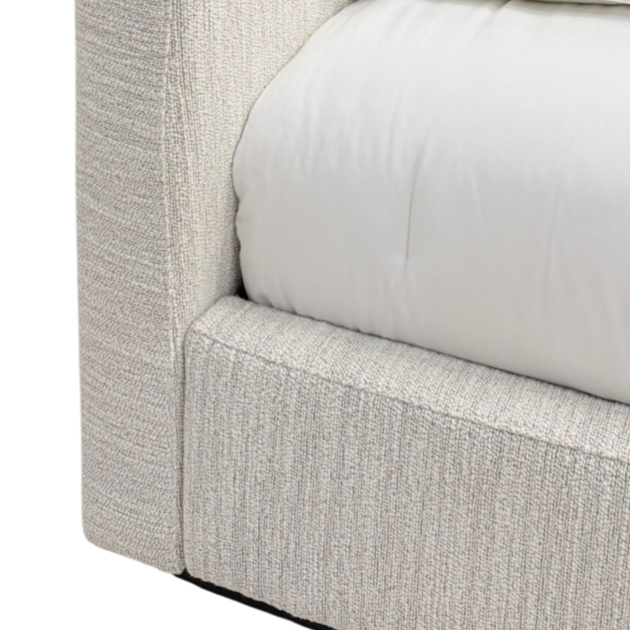 Vital Footboard King Bed close-up showing the textured ivory upholstery, tailored seams and low upholstered bed frame beside the mattress.