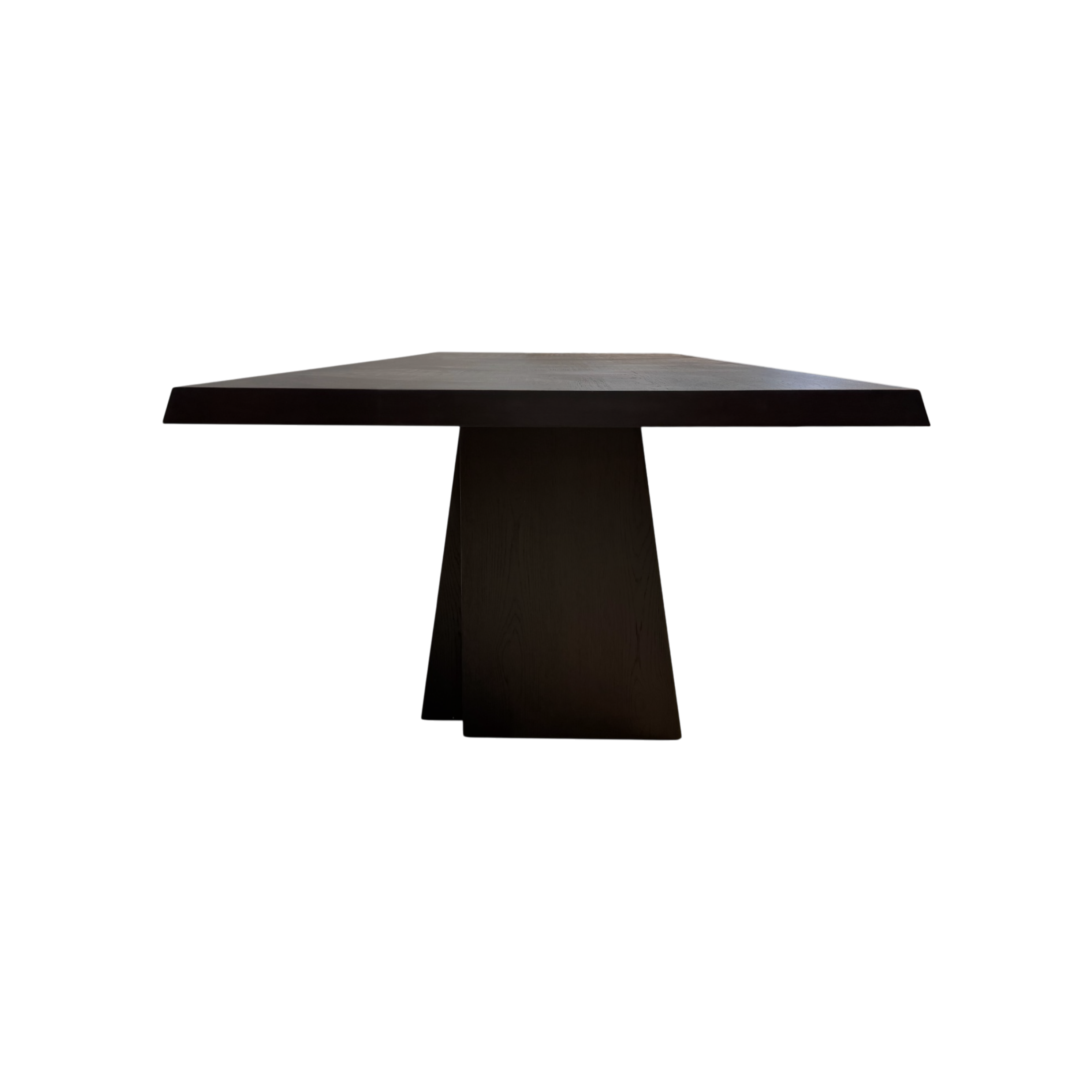 Side view of the Oblique 96-inch Dining Table highlighting the substantial tabletop and architectural tapered pedestal base.