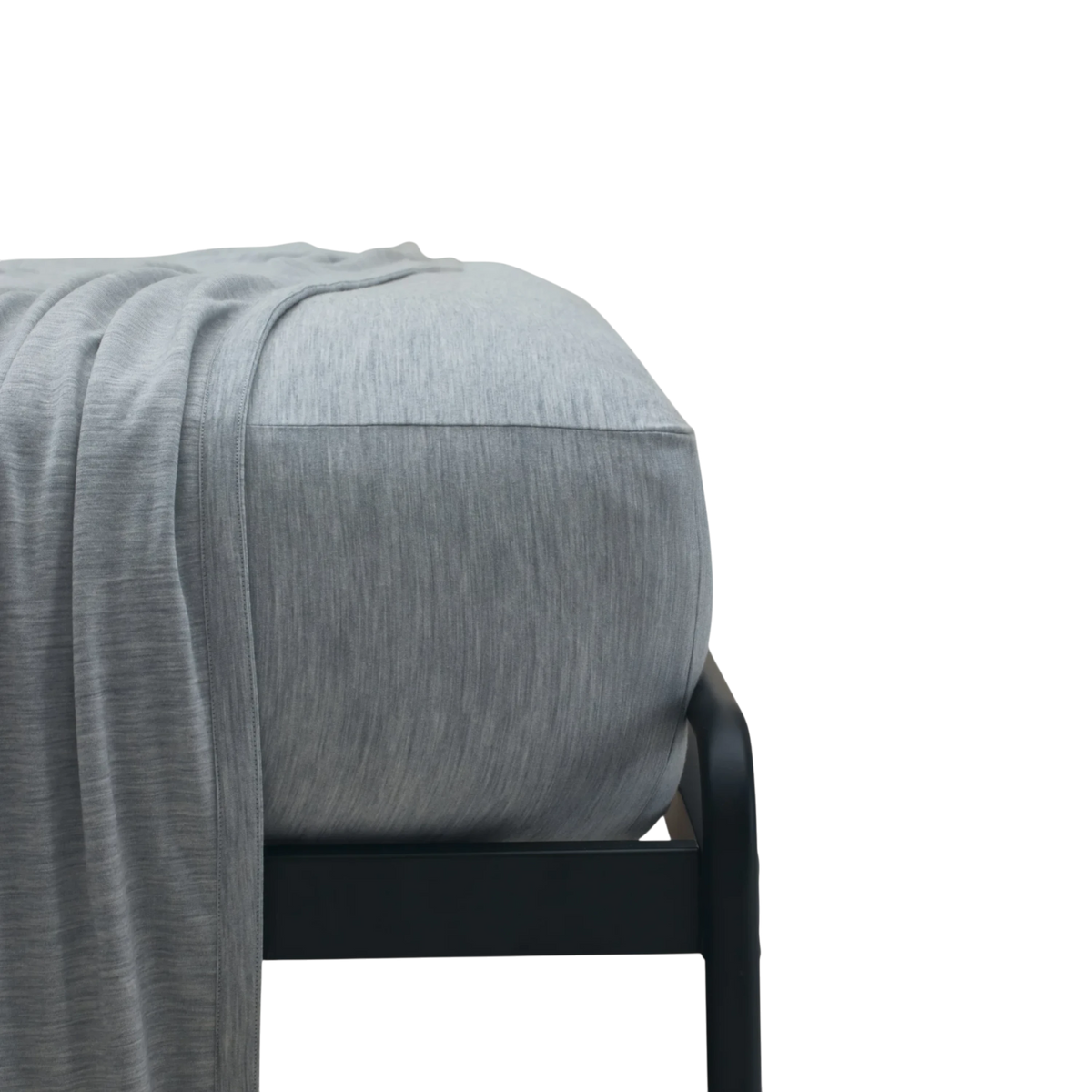 Merino Fit Sheet King in Granite grey Merino Jersey shown fitted over a mattress with coordinating bedding draped over the edge.