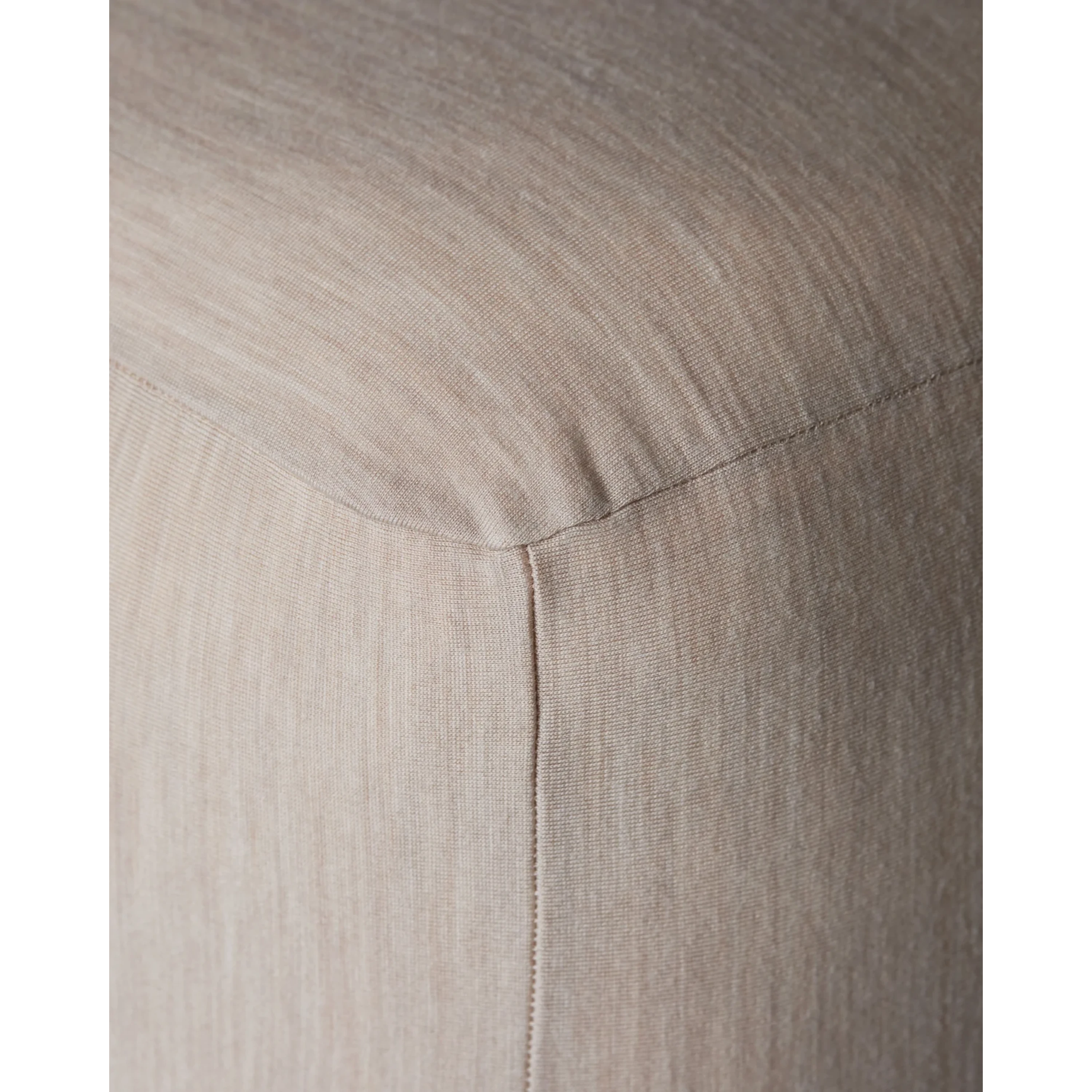 Close-up of Merino Fit Sheet King in Sand showing the smooth jersey texture, fitted corner and tailored seam detail.