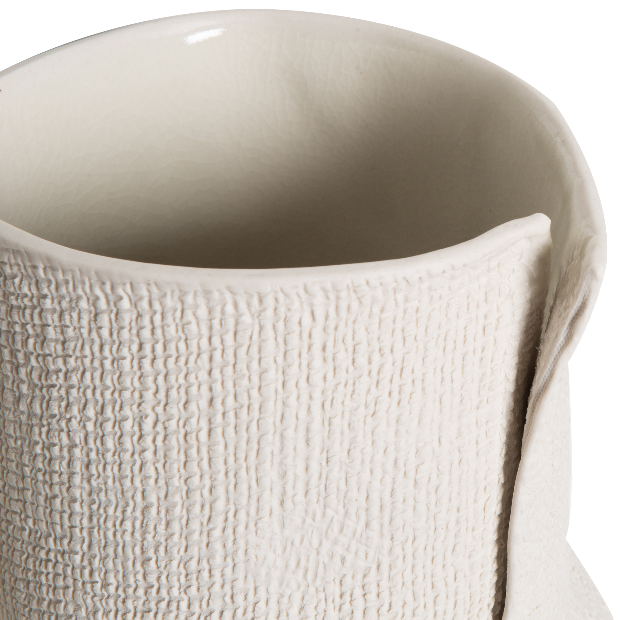 Embracing the beauty of imperfection, the Burlap Bottle Vase is uniquely textured and this intentionally imperfect vase was handcrafted using vitreous high-fire, pure porcelain.