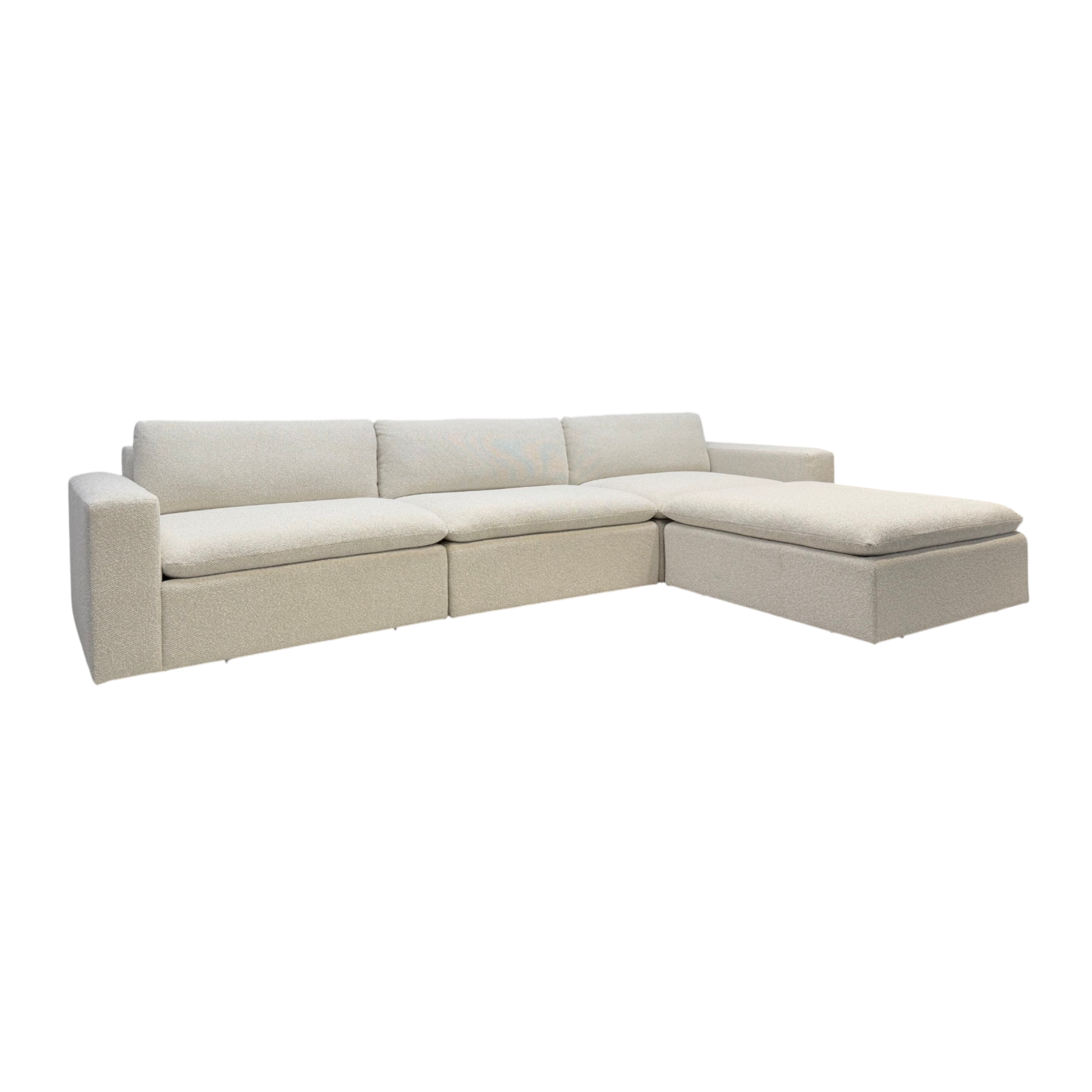 Tempo Modular Sectional in a three-quarter view with ivory textured upholstery, deep cushioned seating, clean-lined arms, and a spacious chaise configuration.