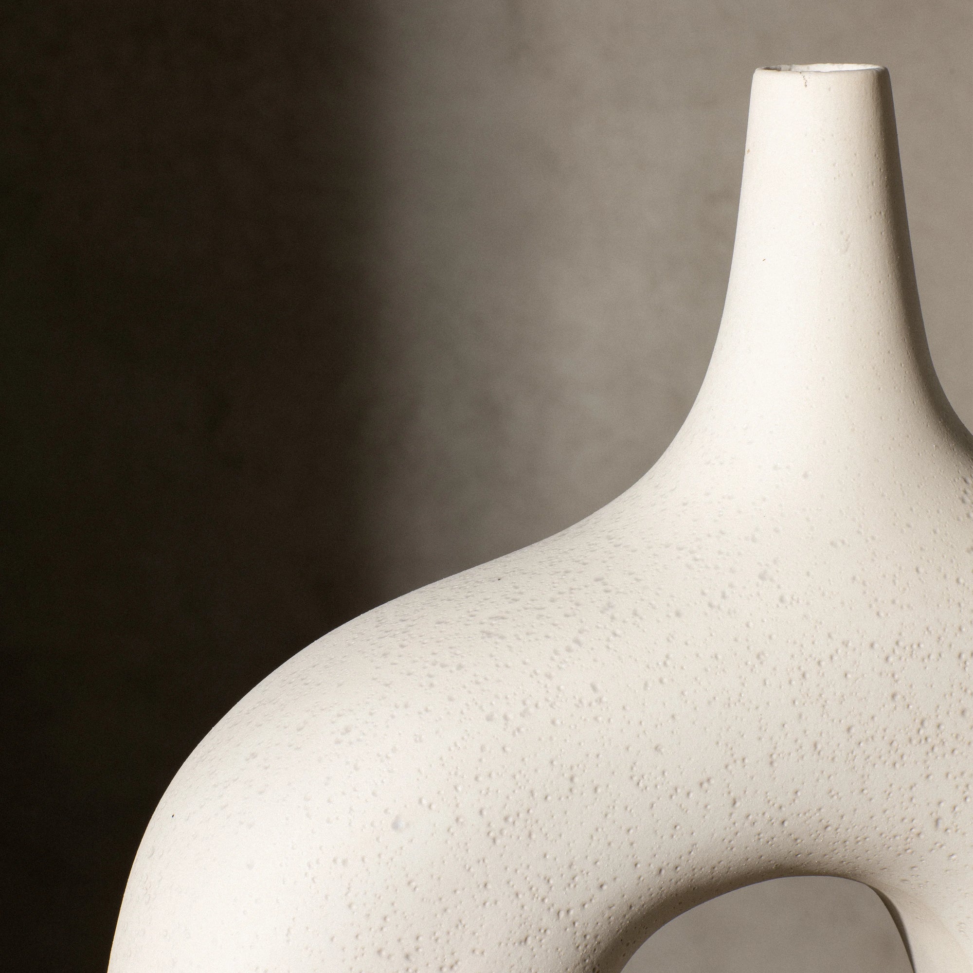 Reminiscent of the 1960's lava glaze ceramics, the Stretch Vases in cream are slip cast vessels that nest/straddle each other.