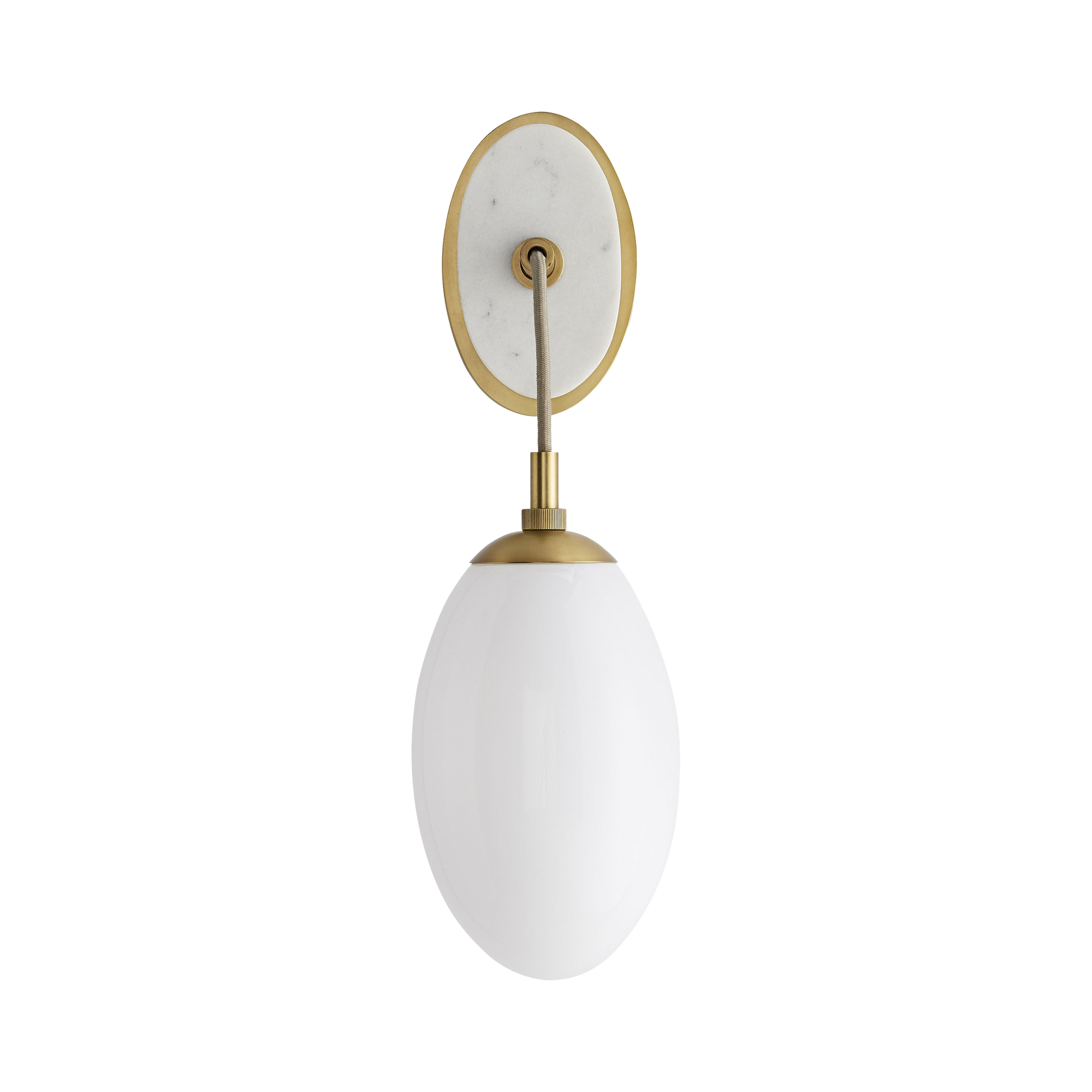An oval, solid white marble stone, backed with steel finished in antique brass, showcases a large teardrop-shaped opal glass shade that is suspended by a taupe cloth cord, establis