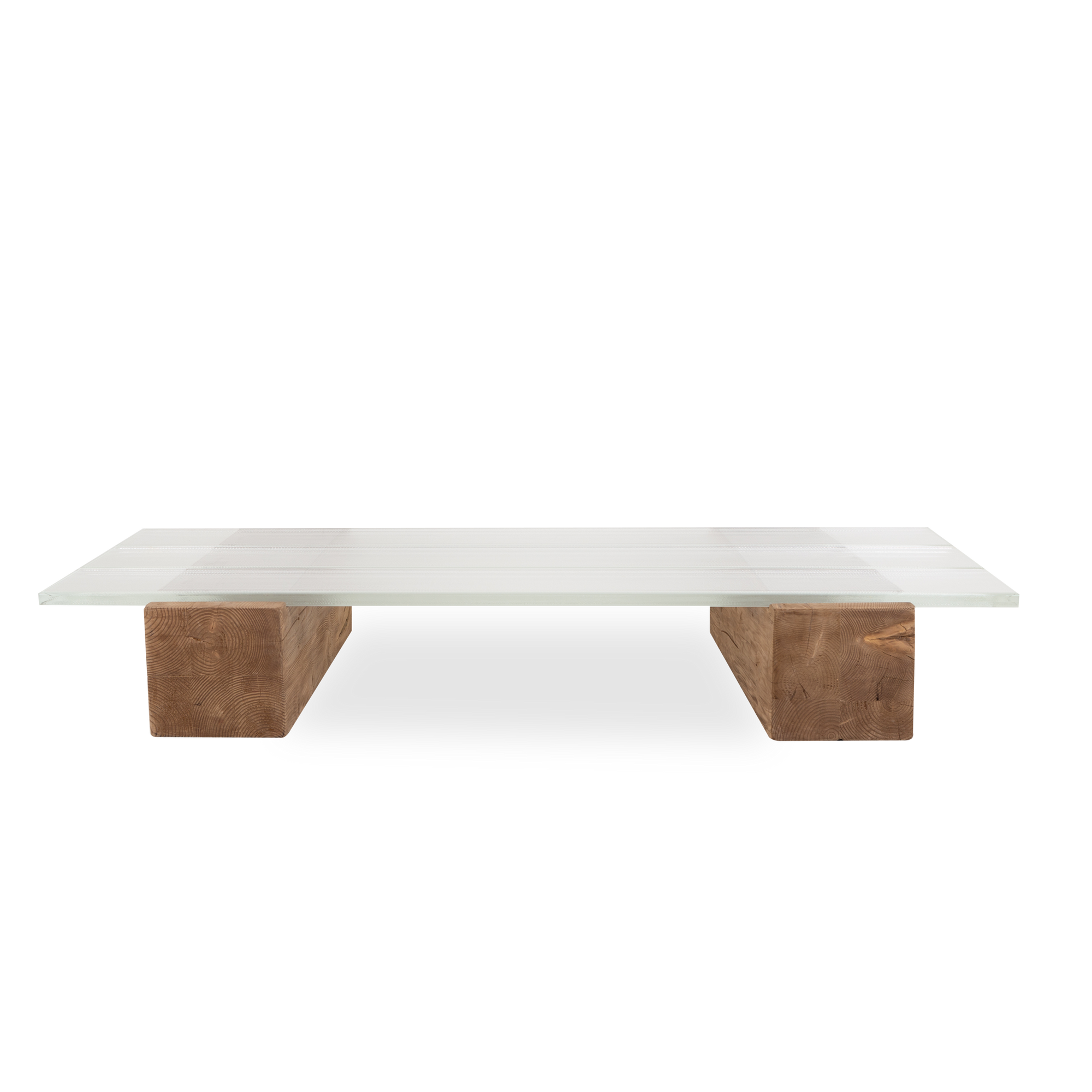 Proving the adage that there is beauty in simplicity, the epic Icebeam coffee table grounds a space with its mighty reclaimed timber blocks topped with three ice-like beams of glas