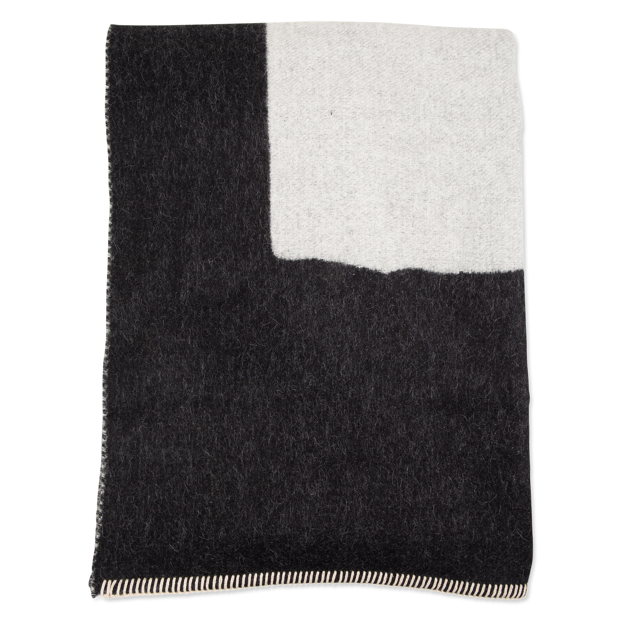 Timeless and simple, the reversible Generation Alpaca Throw is made in Canada.